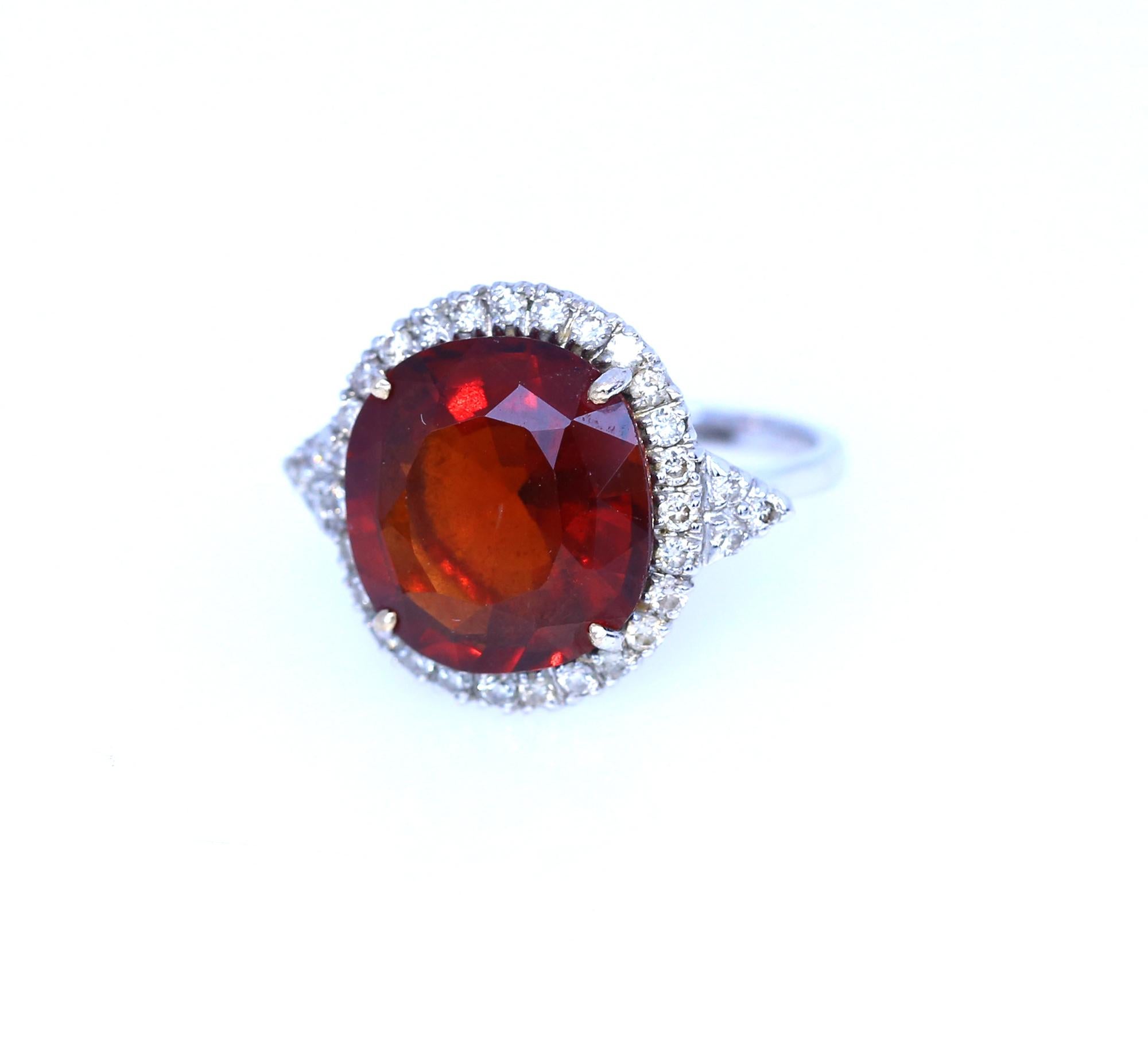 Fine Citrine of deep flame-red colour with Diamonds set around it. A cast of 18K White Gold. Delicate item executed with a great taste. Not too flashy yet important enough to draw attention. Being a part of the 60es generation, the design provides a