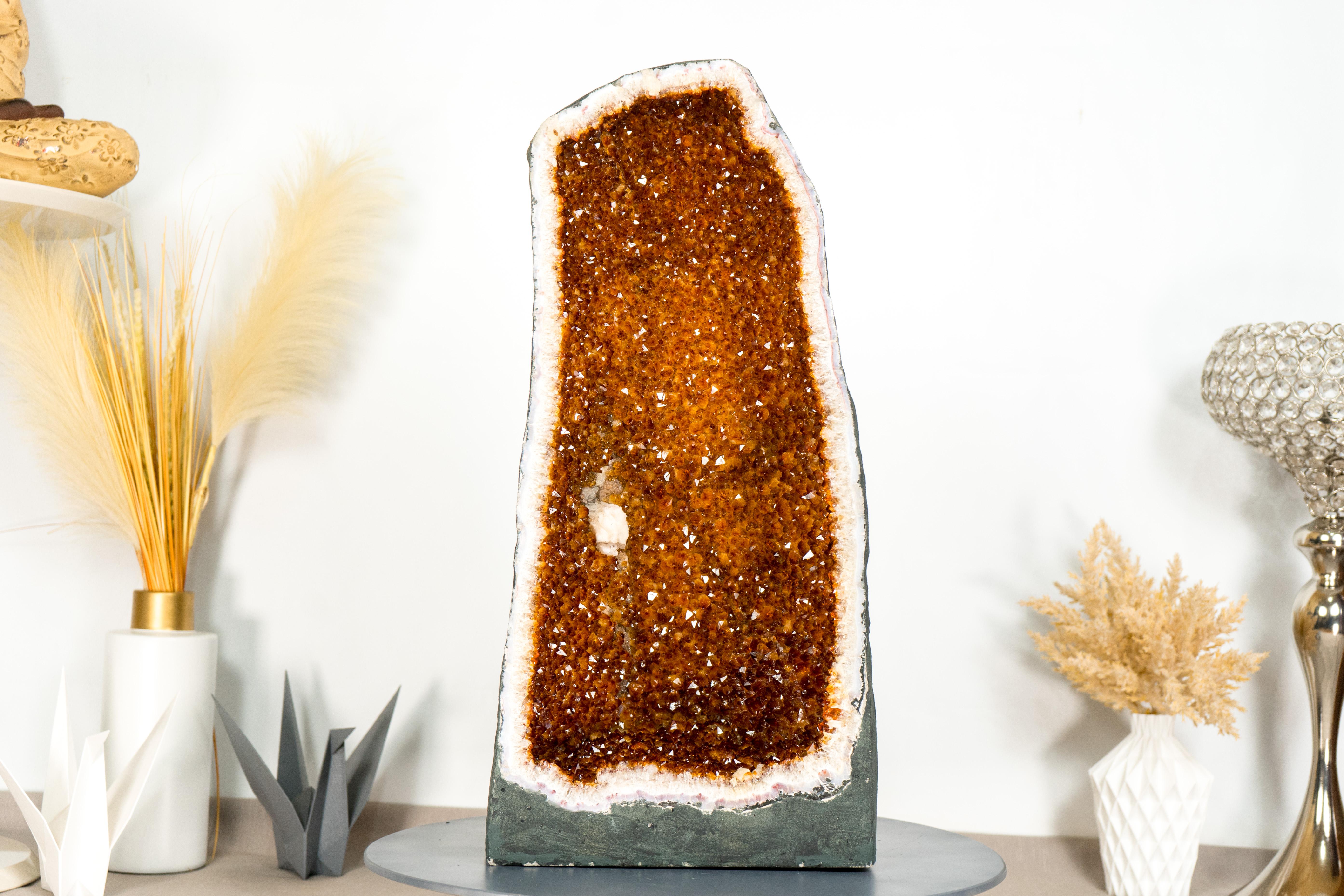 With its stunning deep orange color, this large citrine geode presents a breathtaking display of thousands of deep orange cognac citrine points, special characteristics, and a flawless tall cathedral formation. A AAA (AKA Super Extra) grade geode