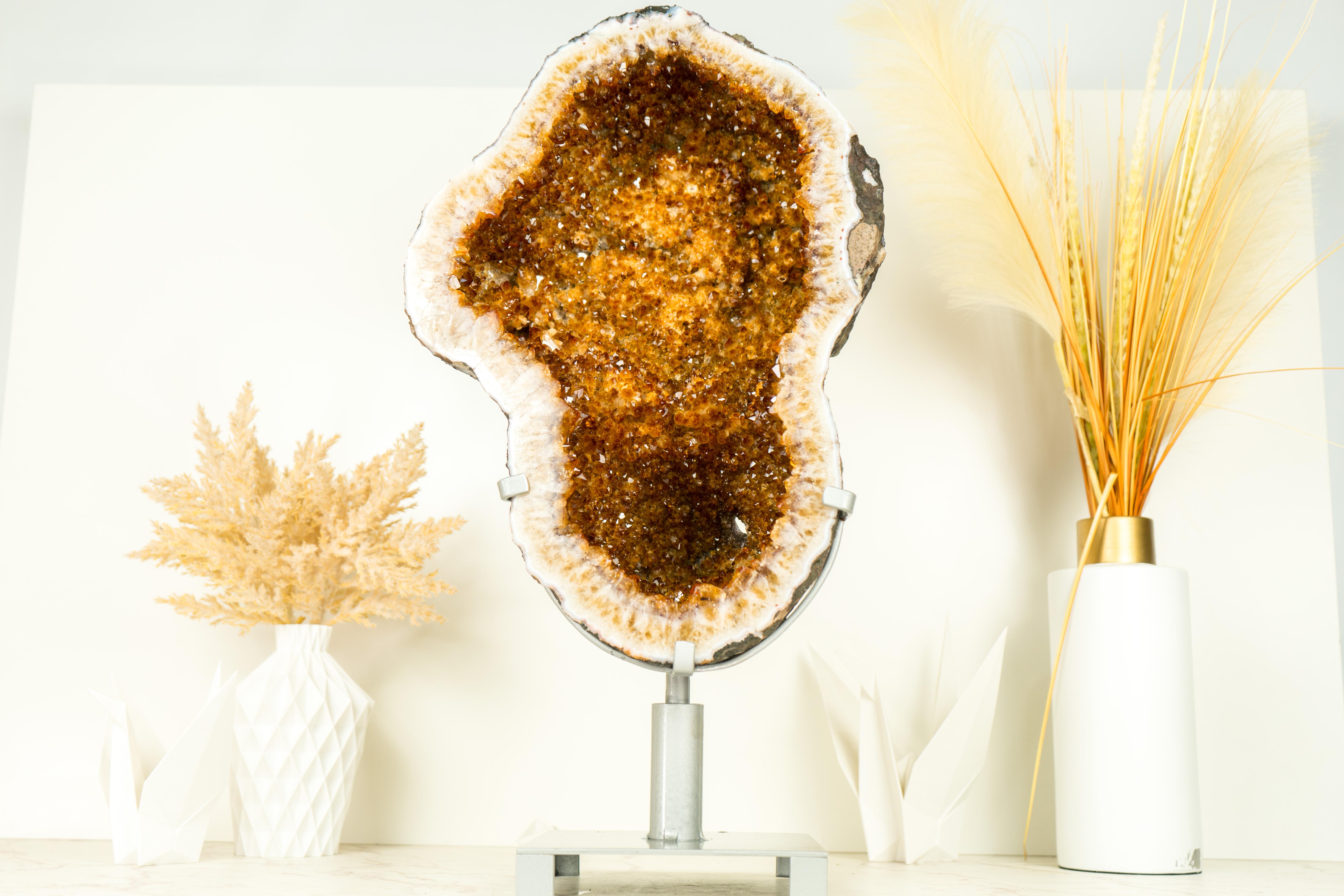 A AAA Citrine Geode that embodies world-class characteristics and stunning aesthetics. Elegantly formed, this geode showcases exceptional golden orange druzy quality, sparkling with flawless crystal formations. This Citrine is undeniably a