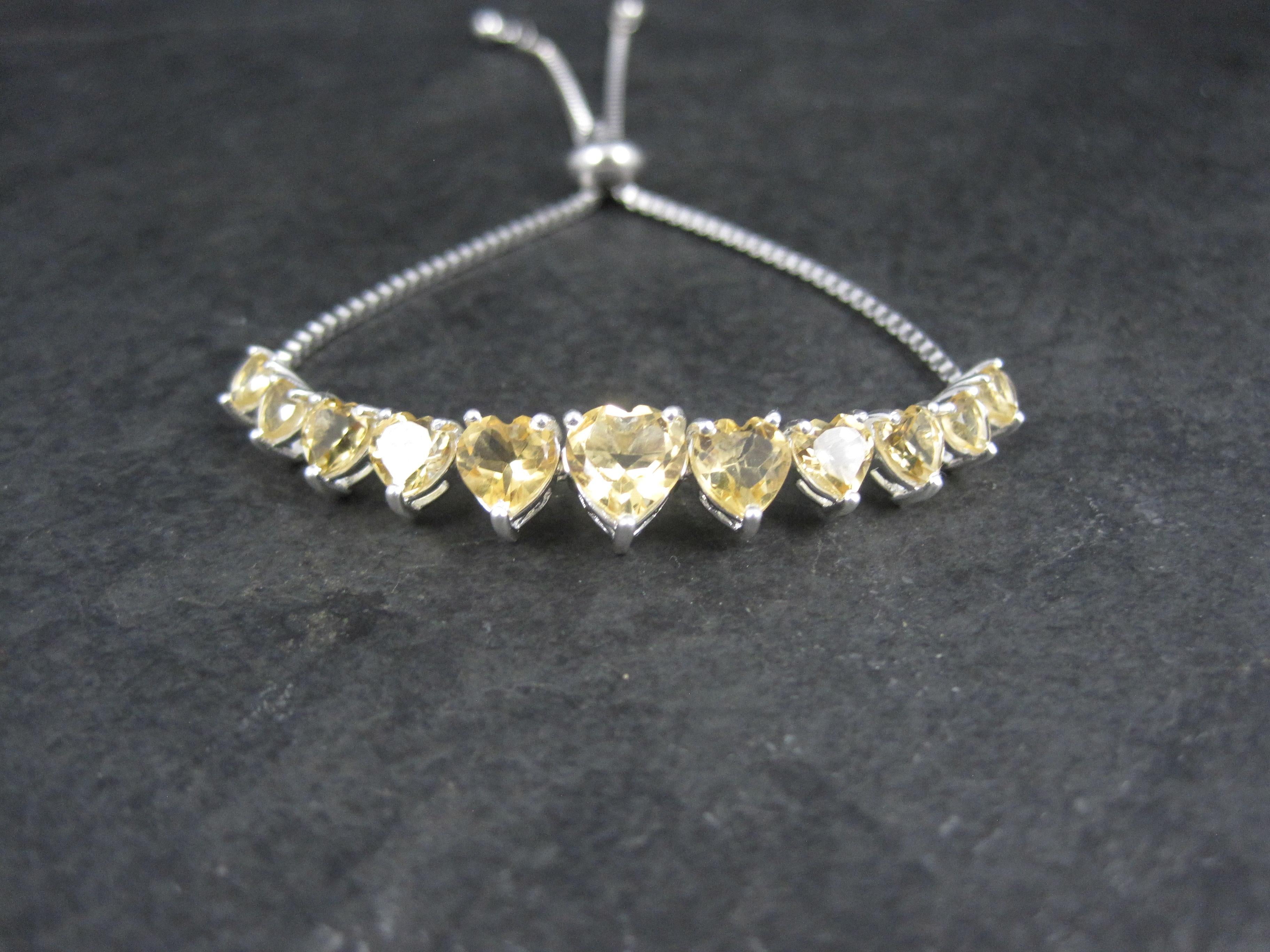 This gorgeous bracelet is sterling silver.
It features an estimated 7ctw in heart cut citrine gemstones.
The face of this bracelet tapers from 5/16 to 3/16 of an inch.
It's bolo design makes it a perfect fit for wrists measuring 5 to 9