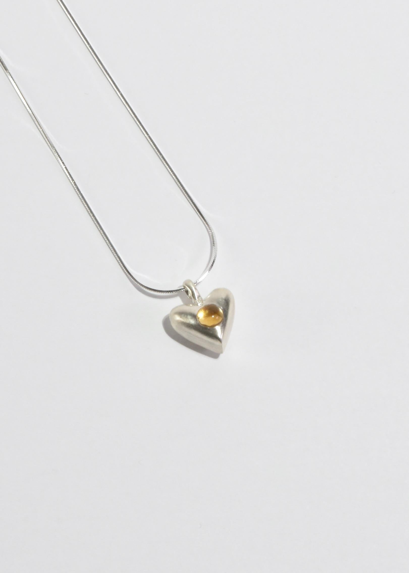 Sterling necklace with a heart pendant and citrine detail. Clasp closure. Inspired by depictions of the Heart as it appeared in early American decorative arts.

Each piece is hand carved, cast, and finished in New York by Owen Dunton of Dunton