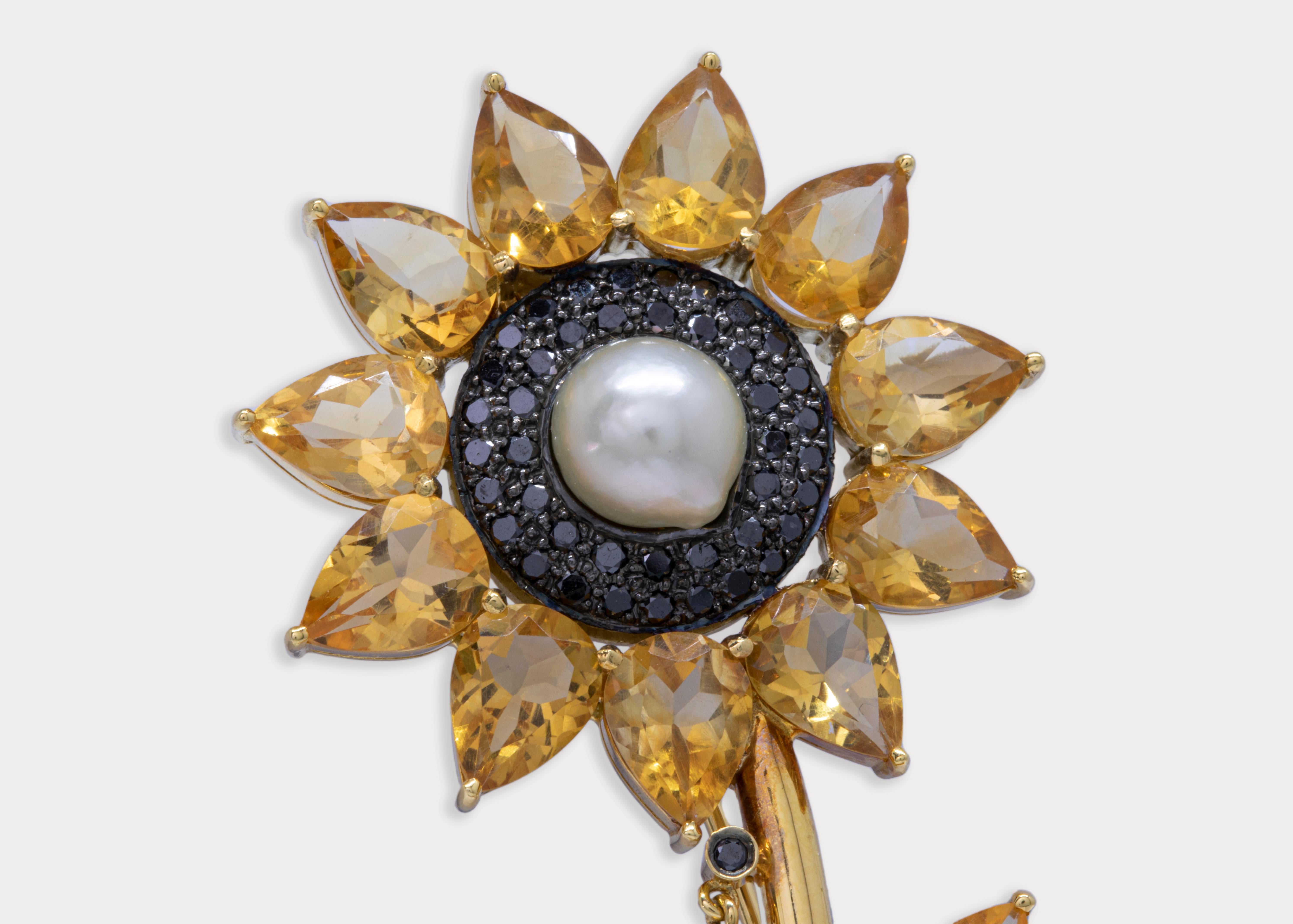 Identical citrine stones double as sunflower petals in this one of its kind 18k yellow gold brooch.
The center pearl is surrounded by black diamonds .

Gold Weight: 16.9 g
5 Pearls Weight: 6.04 ct.
Citrine Weight: 13.35 ct.
Black Diamonds Weight: