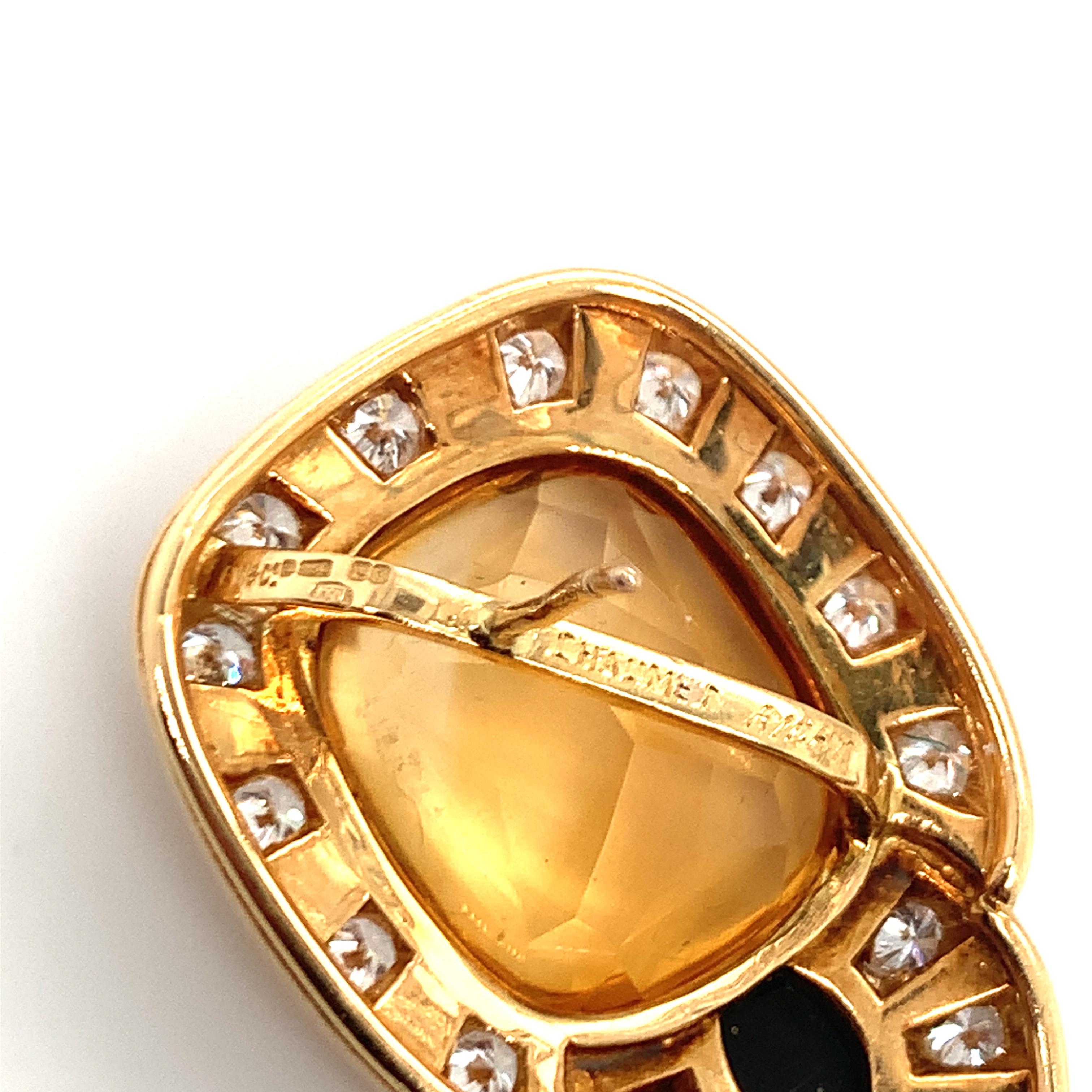 Citrine, black Onyx and diamond 18K yellow gold earrings by Chaumet featuring two cushion cabochon cut citrines totaling 25 ct. with a black onyx accent below each stone. The earrings are further accented by 36 round brilliant diamonds weighing 2.25