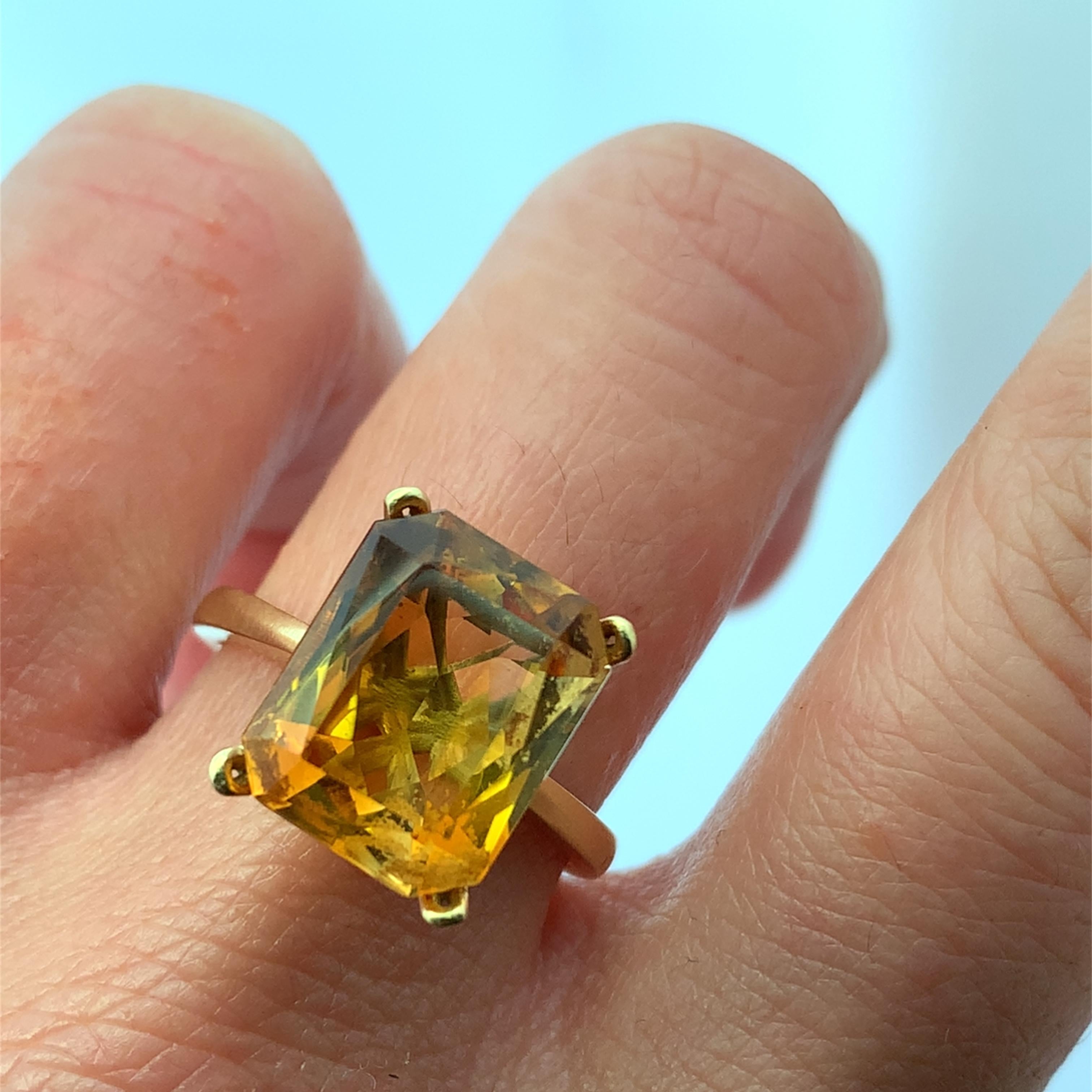 Cette bague exquise est ornée d'une citrine dorée radieuse de 6,10 carats, élégamment sertie dans un anneau classique en or jaune 18 carats. La teinte vibrante de la citrine mesurant environ 13x11mm de largeur et 7 de profondeur capture
