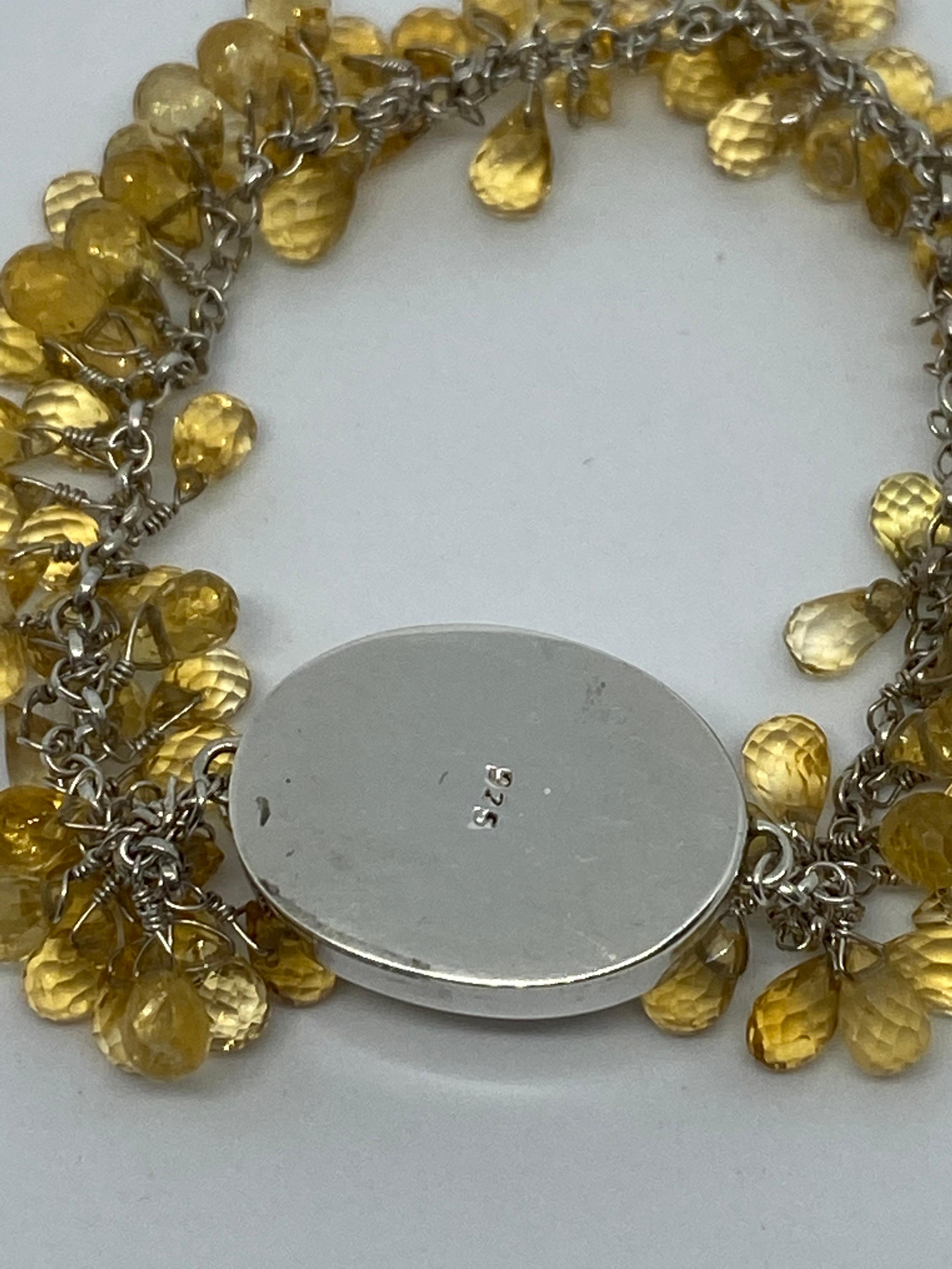 This bracelet fully extended measures 8 inches in length and is adorned with beautifully clean and clear Citrine Briolettes that are all hand wire wrapped into the bracelet for a dangling effect. The Center Large Oval Citrine is Approx 15.5 x 9.6mm