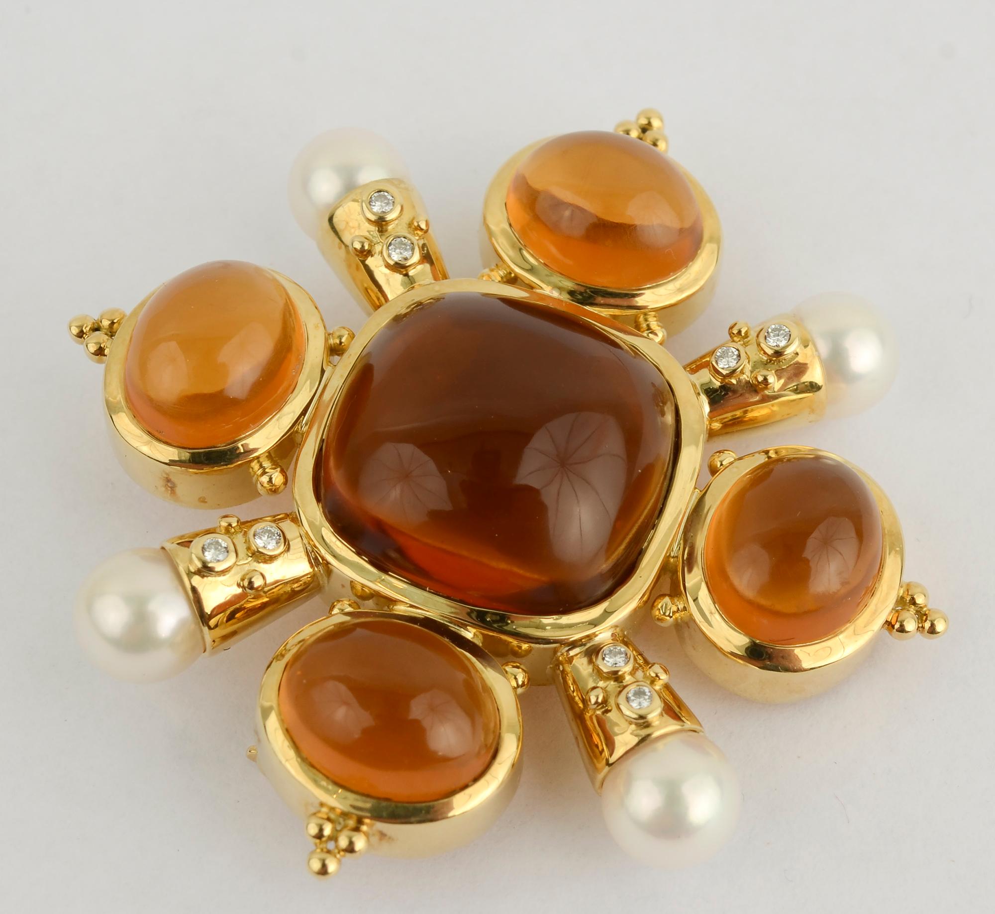 Striking brooch of warm, honey colored citrine; pearls and diamonds. Each of the arms supporting the pearls has two diamonds and two gold balls. The balls echo the tips of the oval citrines.
The brooch measures 2 1/16 inches in diameter and 1 7/8