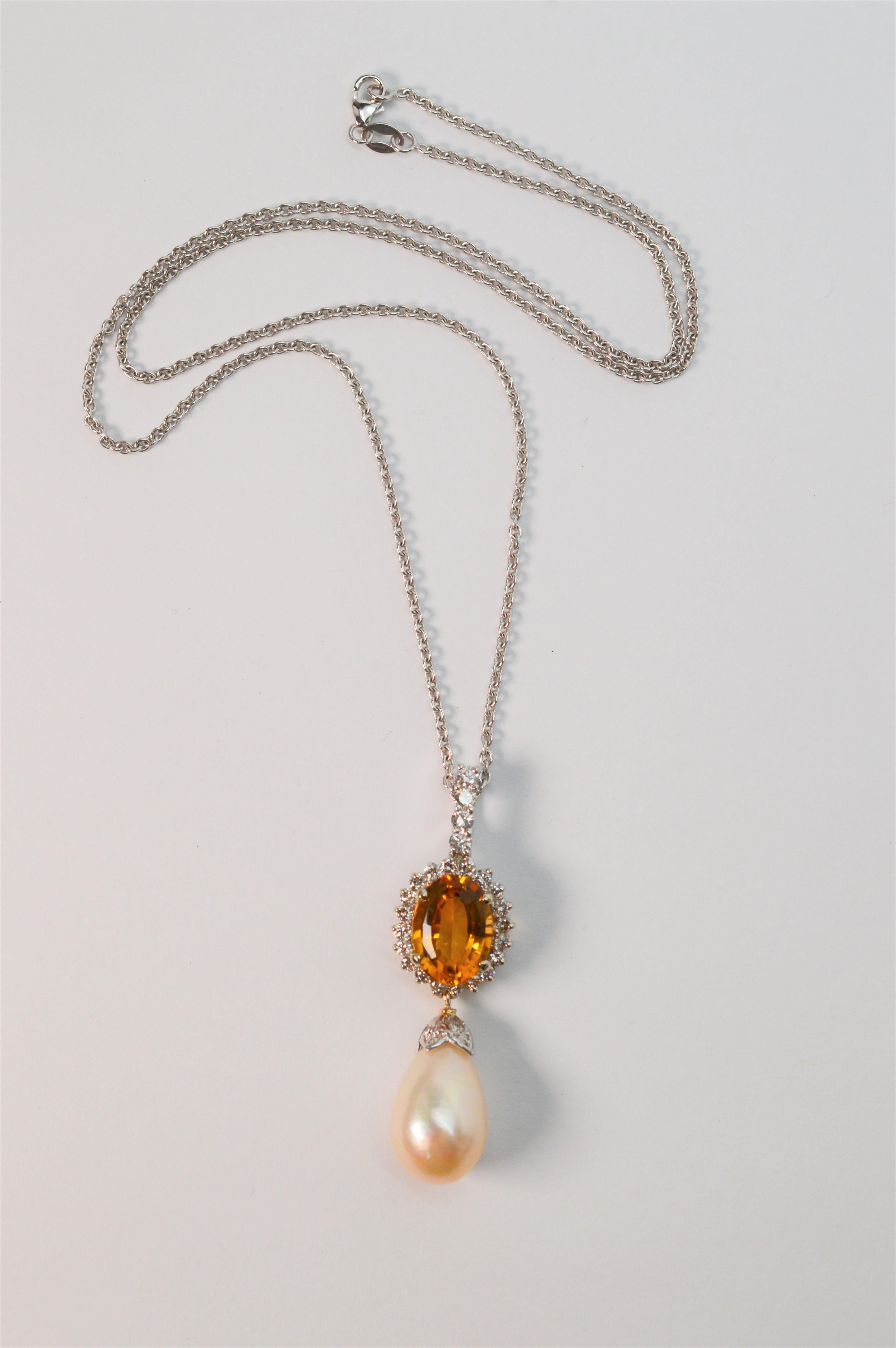 The undeniable fire of a faceted 4.5 carat oval citrine set aglow by sparkling rock crystal accents adds to the regal drama of the genuine 11 mm tear drop shaped pearl pendant. Italian made and created in fourteen karat 14K white gold, this elegant