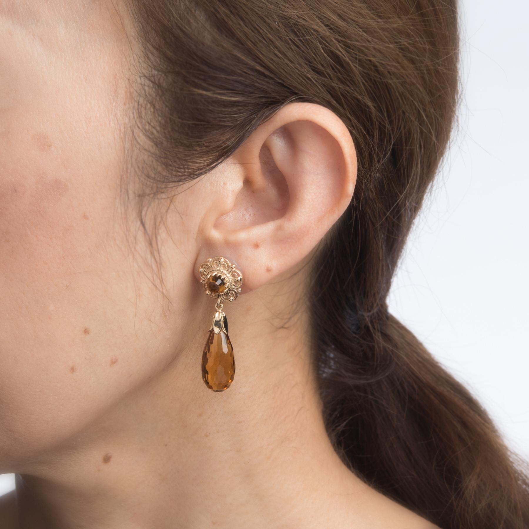 Elegant pair of citrine pendant drop earrings, crafted in 14k yellow gold. 

Briolette faceted citrine measures 20mm x 10mm (lower) and two estimated 0.50 carat citrines (upper). The citrines are in excellent condition and free of cracks or chips. 