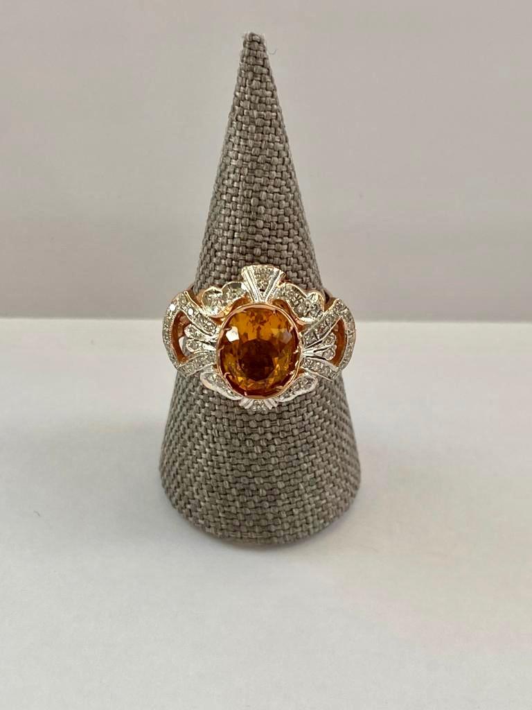 Diamonds, citrine quartz, silver and rose gold (14k) ring. The upper part of the ring is made out of silver, the lower part is made out of pink gold with the hallmark. It is composed of a central oval citrine quartz of circa 8 carats, surrounded by