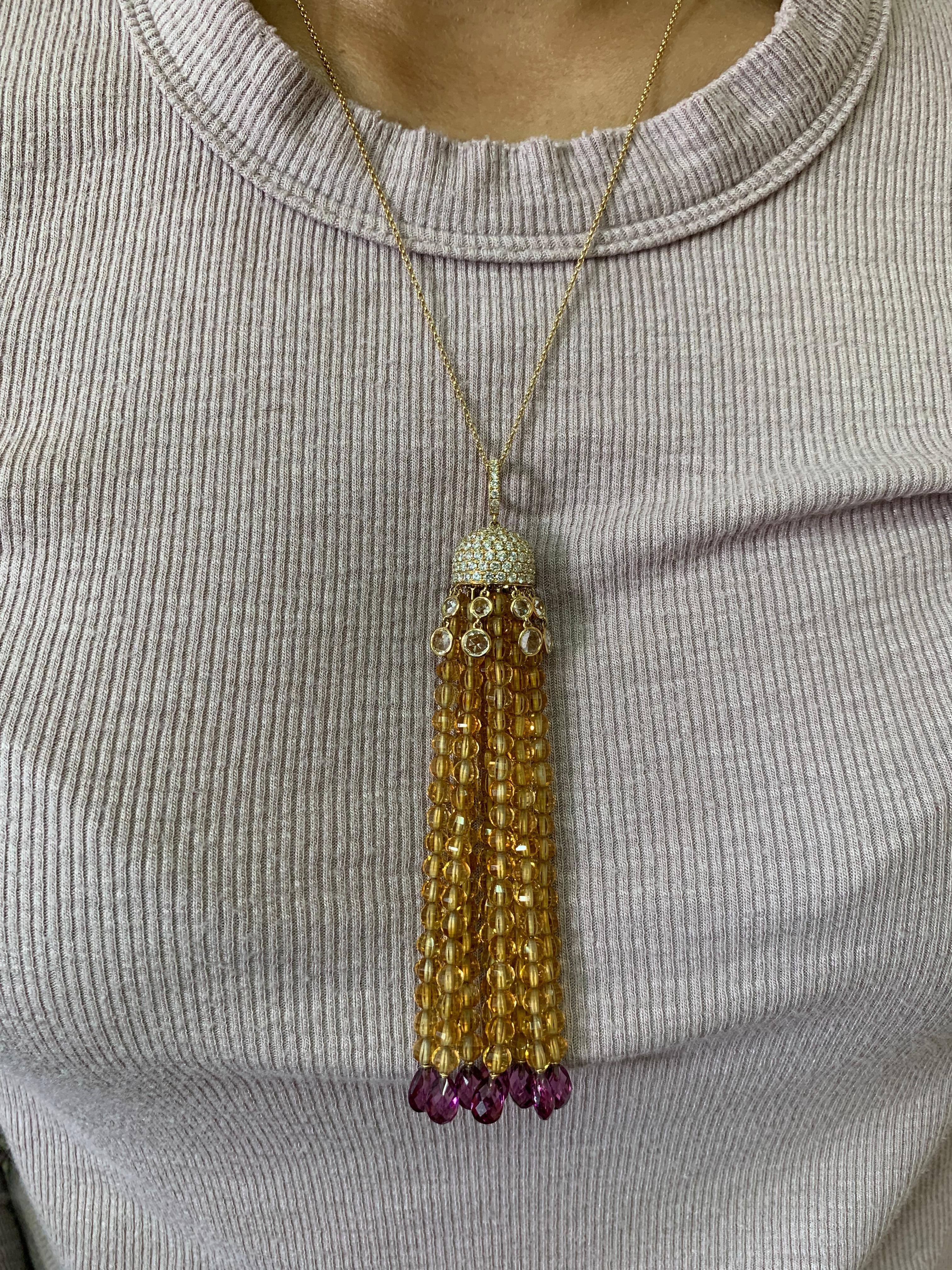 This is an elegant citrine, rhodolite garnet, and crystal necklace using a mixture of cuts to accentuate the beauty of the gemstones. This is a light and fun drop necklace with a pop of color with the use of these colorful gems.

Designer citrine,