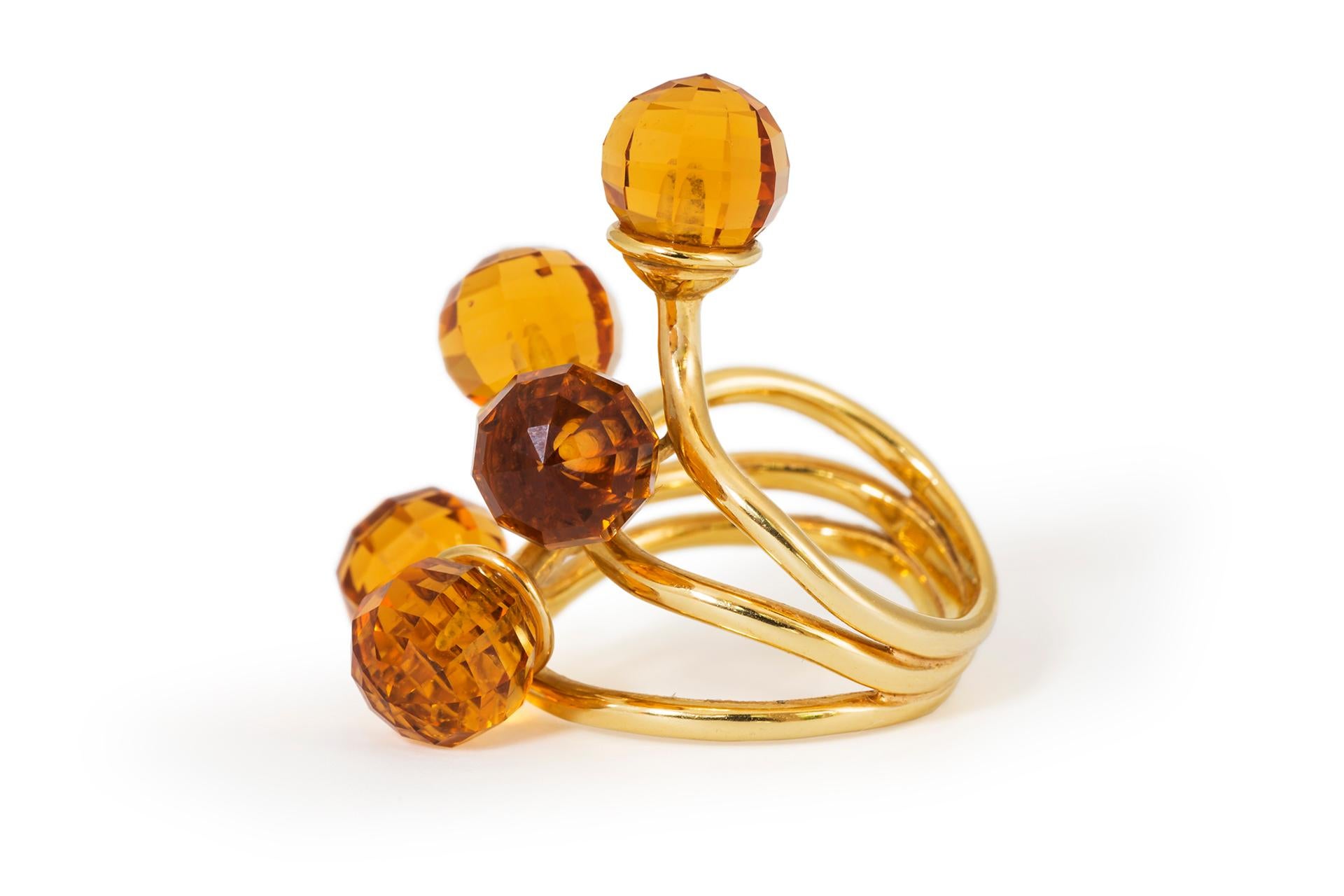 Madeira citrine ring featuring five briolette cut gemstones set with interwoven 18ct gold bands to form an unusual contemporary design. 

Size 5.5
Length 3cms 
Width 2cms 
Weight 13.6gms 