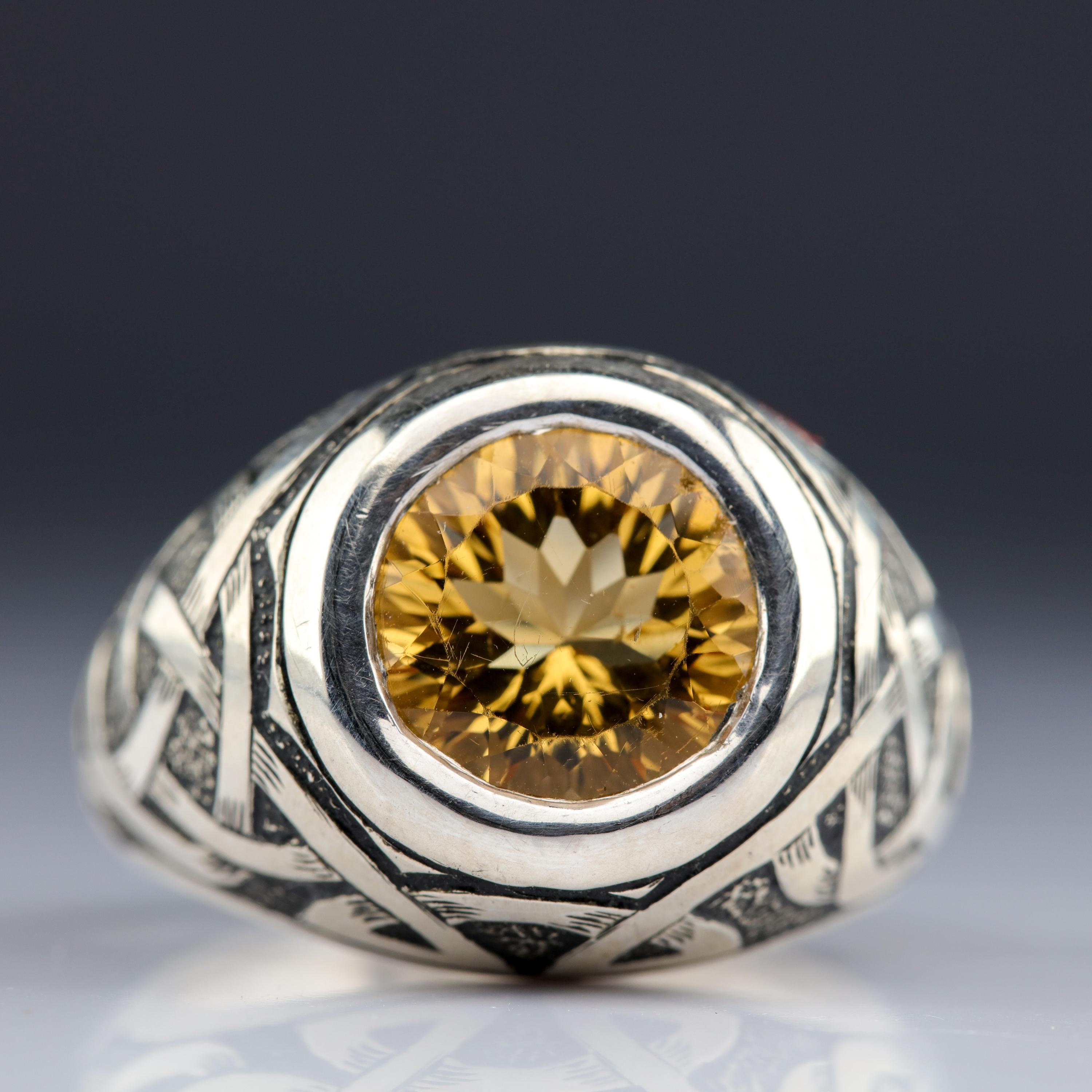 This men's citrine ring will absolutely survive the zombie apocalypse. It's 36 grams—that's one-and-a-quarter ounce—of ring. A round, beautifully faceted custom-cut citrine is bezel-set front and center, and at 11. 75 mm in diameter, weighs in at a