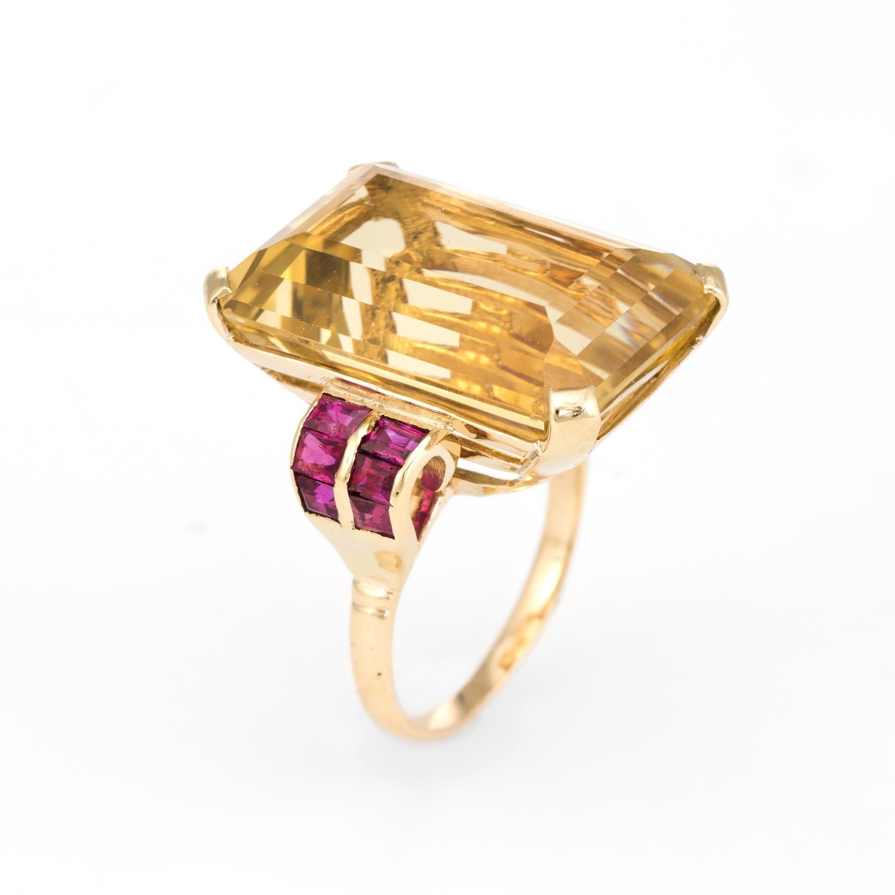 Dramatic large vintage statement cocktail ring (circa 1940s to 1950s), crafted in 14 karat yellow gold. 

Centrally mounted emerald cut citrine measures 21mm x 14mm (estimated at 25 carats), accented with 12 approx. 0.05 carat emerald cut rubies.