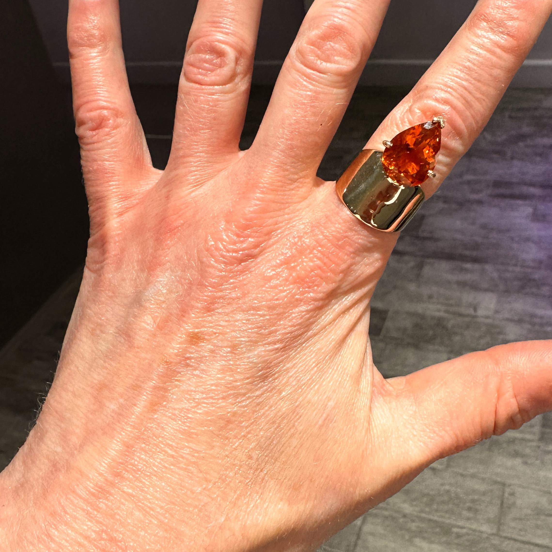 Sail off into the sunset with this gorgeous new statement ring from Eytan Brandes.  Besides the stone, this is basically a cigar band -- tapering from 16mm in the front to a comfortable 4mm in the back.  But Eytan has perched a fiery madeira citrine