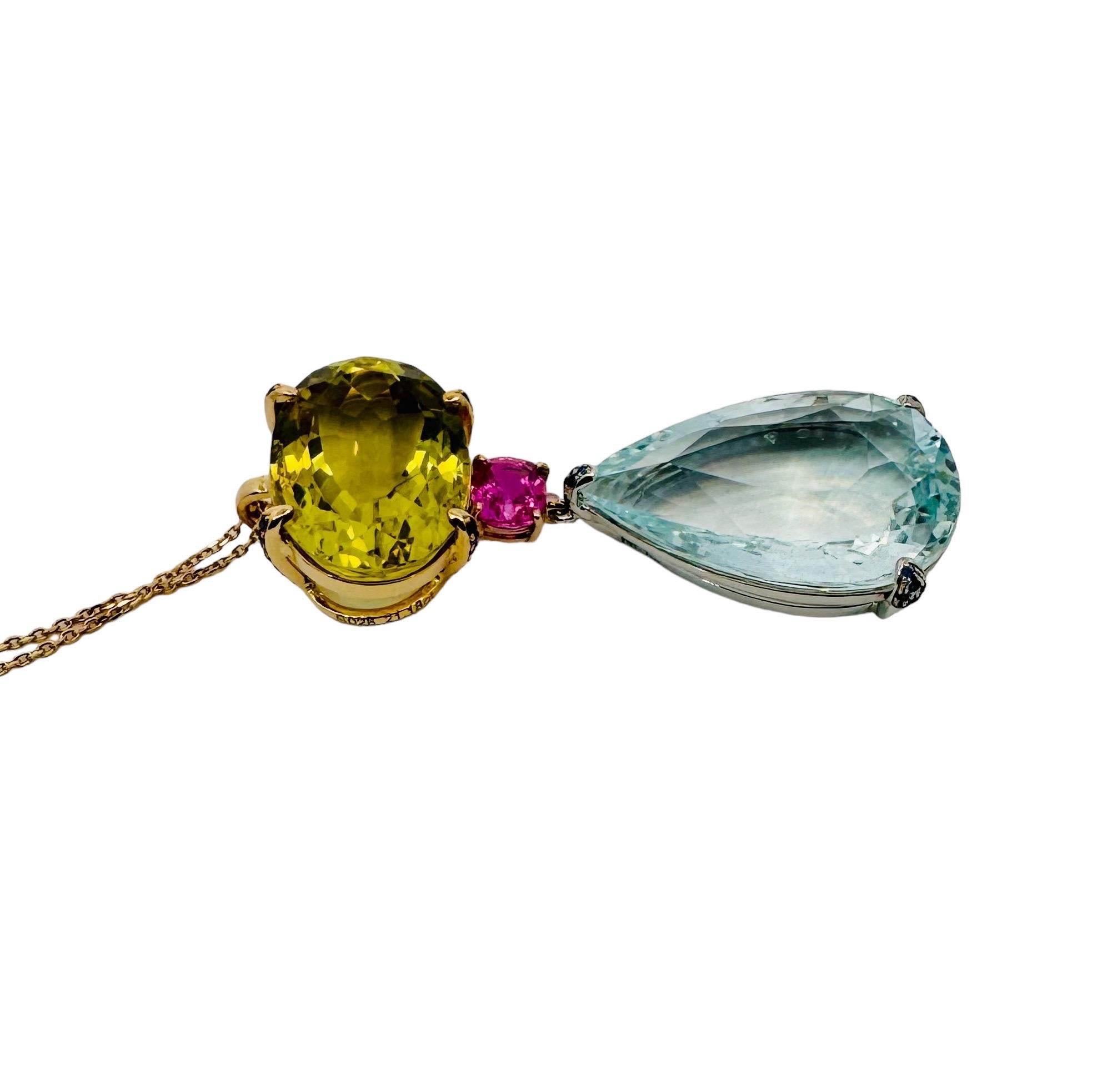 Indulge in a symphony of colour with this exquisite pendant from bo•be jewellery. Crafted in 18ct white and yellow gold, this piece showcases a dazzling array of gemstones. An oval citrine takes centre stage, embraced by blue sapphires, while a