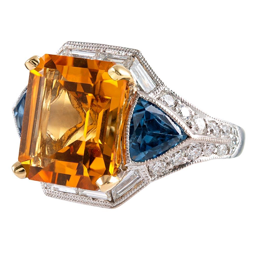 An uncommon, yet highly symbiotic  combination of gemstones, the design centered upon a 6.50 carat emerald cut citrine, this ring can compliment casual, professional or formal attire and will look well with any color palette. Citrine is a