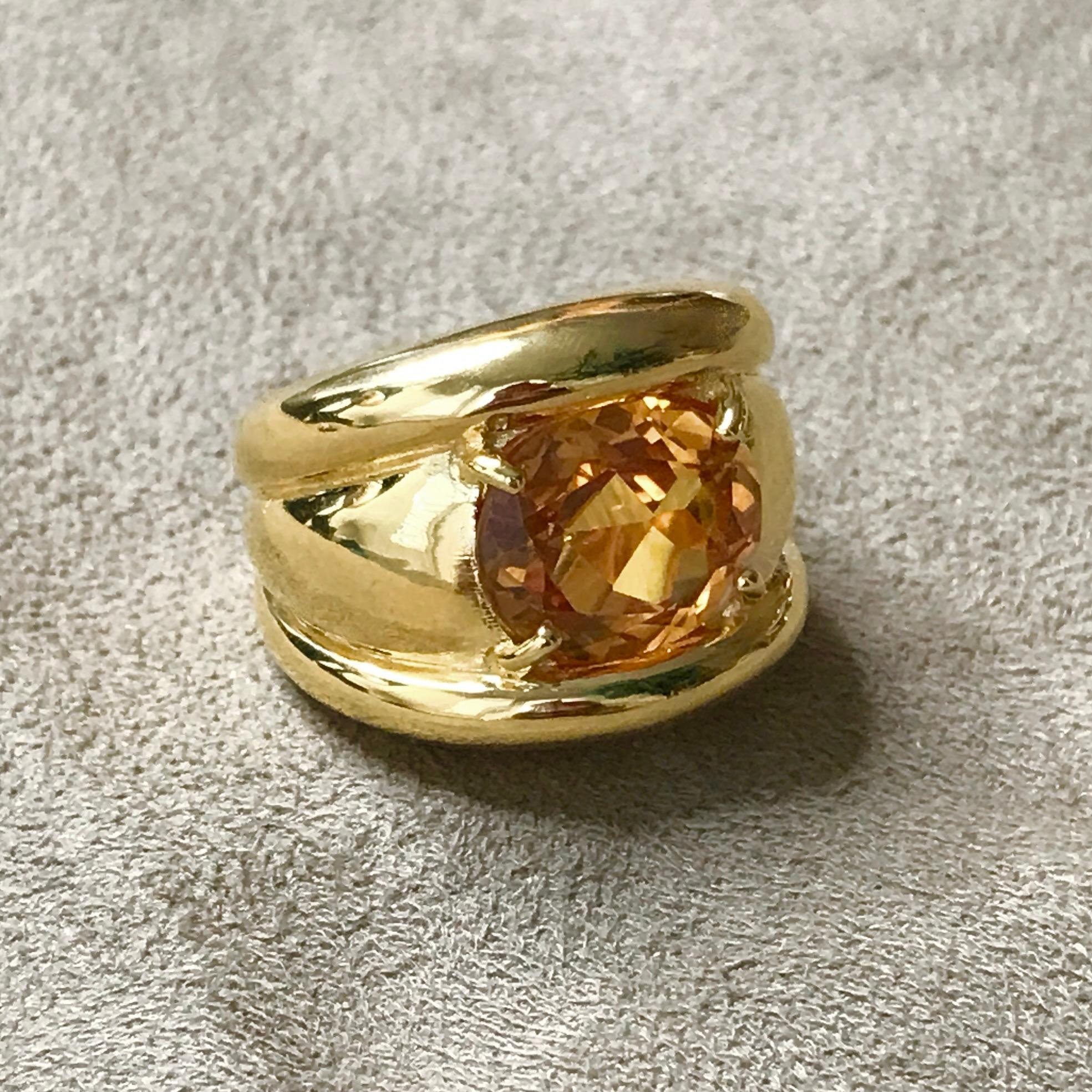 A wonderfully stylish Cocktail Ring, claw set with a beautiful, bright & lustrous cushion shaped Citrine. 

The central, gently domed section set with a large Citrine, flanked to either side by a raised, narrow domed 'band', framing the stone -