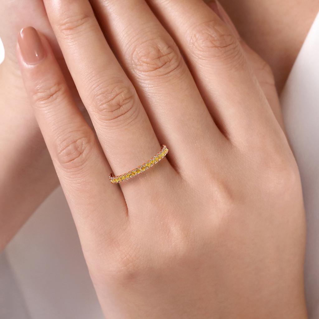 This ring is set with bright orange citrines for a slim and shimmery accent, perfect for celebrating a November loved one! These bands stack beautifully and also look great by themselves! Round citrines are set 3/4 around the band. The 14 karat gold
