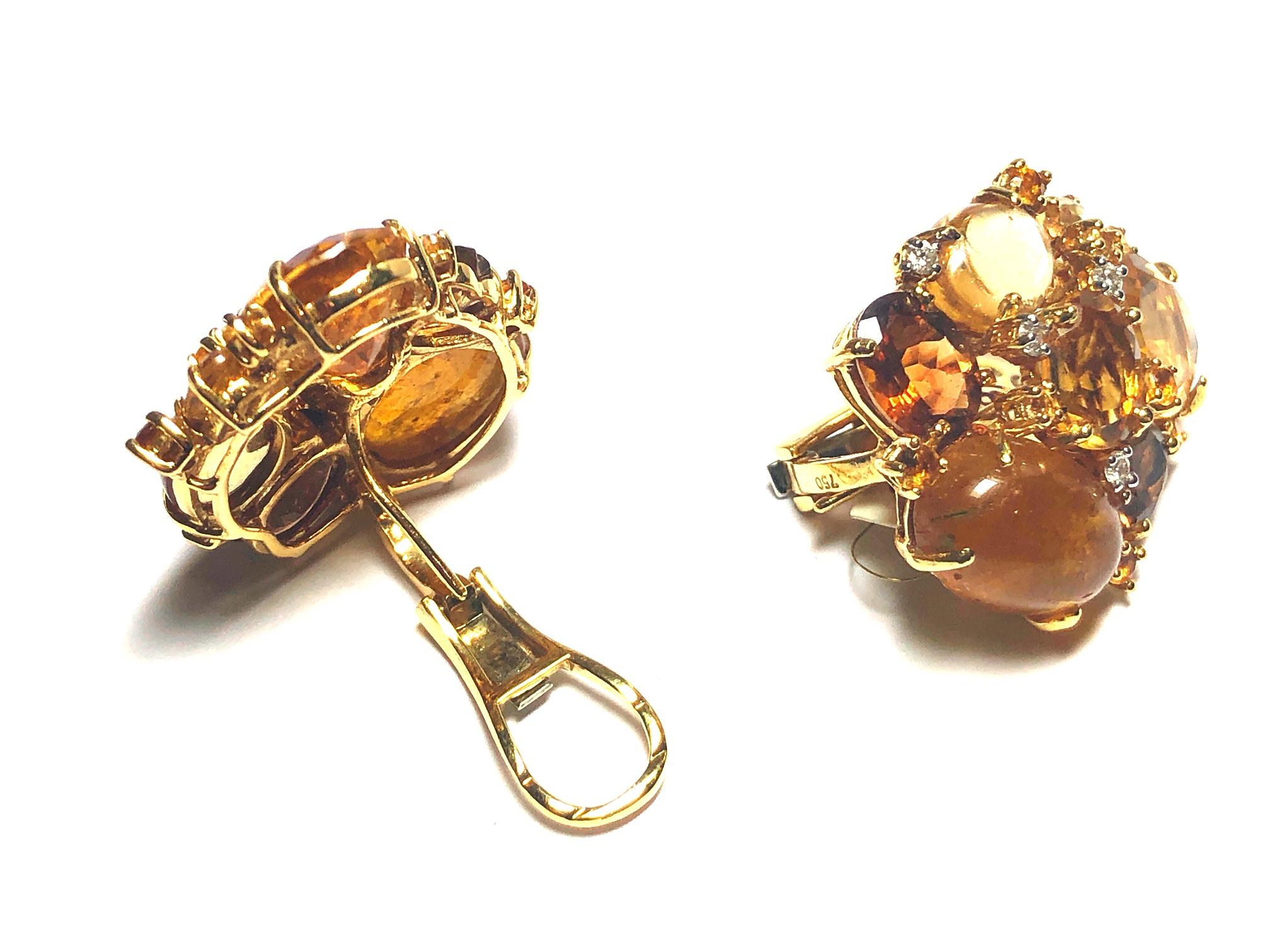 A pair of citrine and tourmaline cluster earrings, mounted in gold, set with mixed-cuts of citrine, yellow tourmaline and with round brilliant-cut diamonds.
