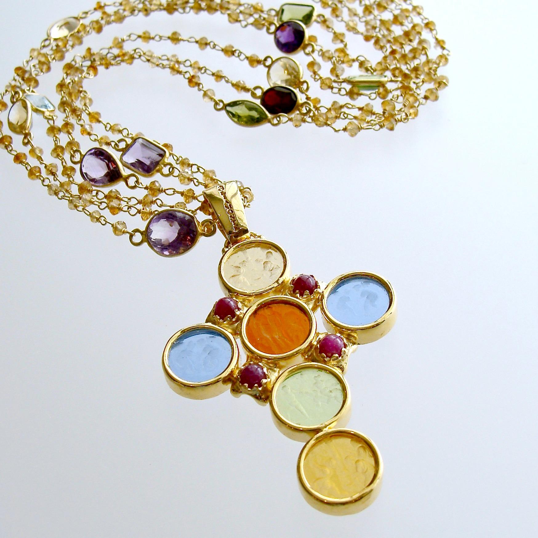 A gorgeous cross pendant consisting of six minuscule Venetian glass intaglios set in a Byzantine bezel setting and accented with rubies is the focal point of this elegant necklace.  Assorted bezel gemstone connectors of citrine, blue topaz, peridot,