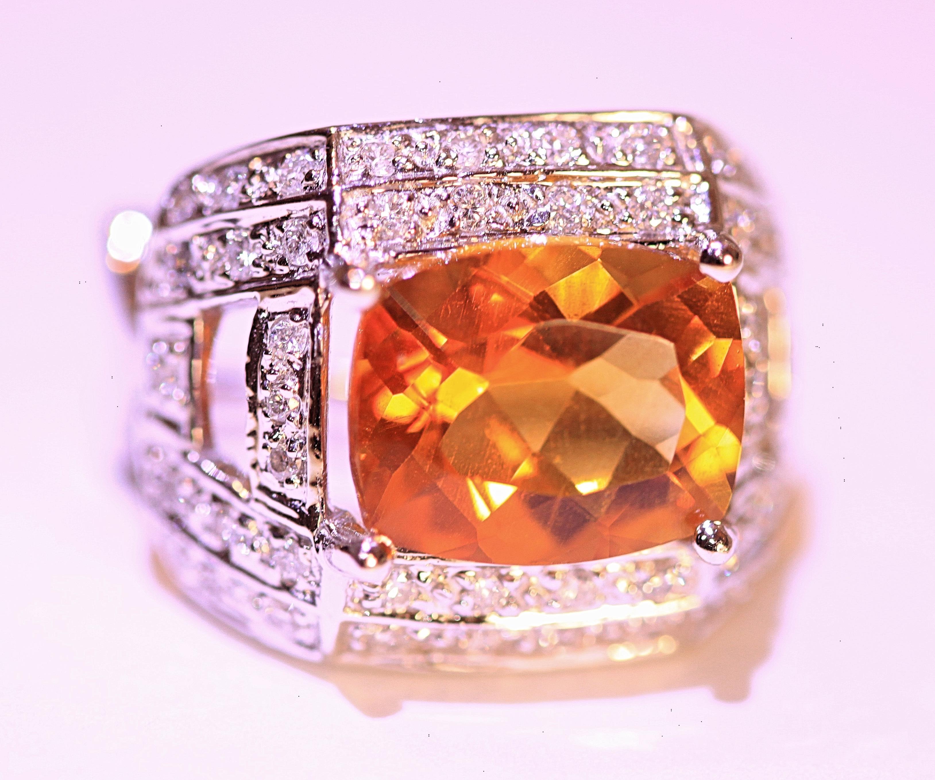 Bright, sparkling orange citrines that measure 11 mm x 9 mm.  The stones are multifaceted with an elongated shape.  The citrines are surrounded by pave' round diamonds and the earrings have posts and clip backs.  The total measurements of the