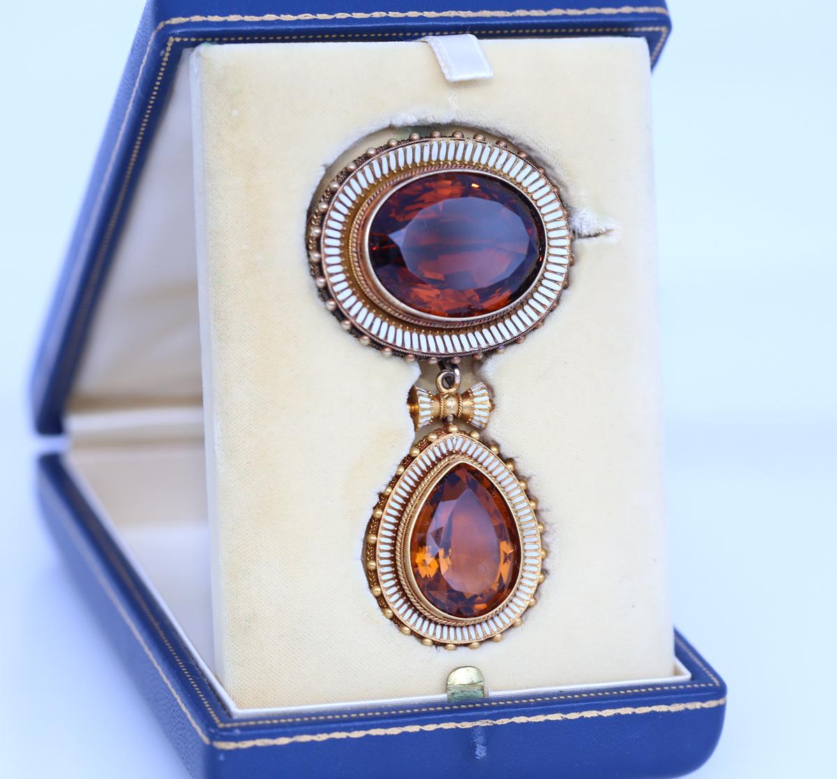 Massive Citrine and White Enamel brooch that is also a pendant. Transformable into two separate pendants. Amazing level of jeweler craftsmanship with finest detailing.  
The pendant/brooch is of the age where the components may be a combination of