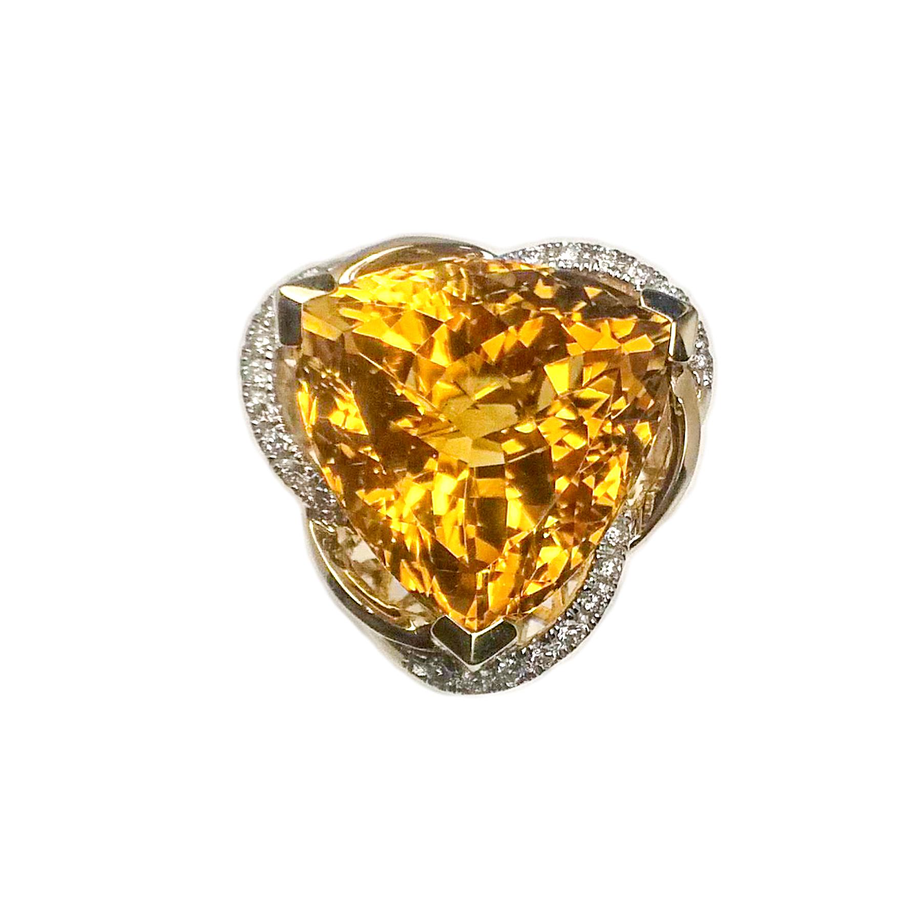 Honey yellow, 13.27 carats citrine and diamond ring. High luster, trillion faceted citrine mounted in high profile basket with 3 prongs. Contemporary handcrafted design with round brilliant diamonds, set in 14 karat yellow gold. Ideal cocktail