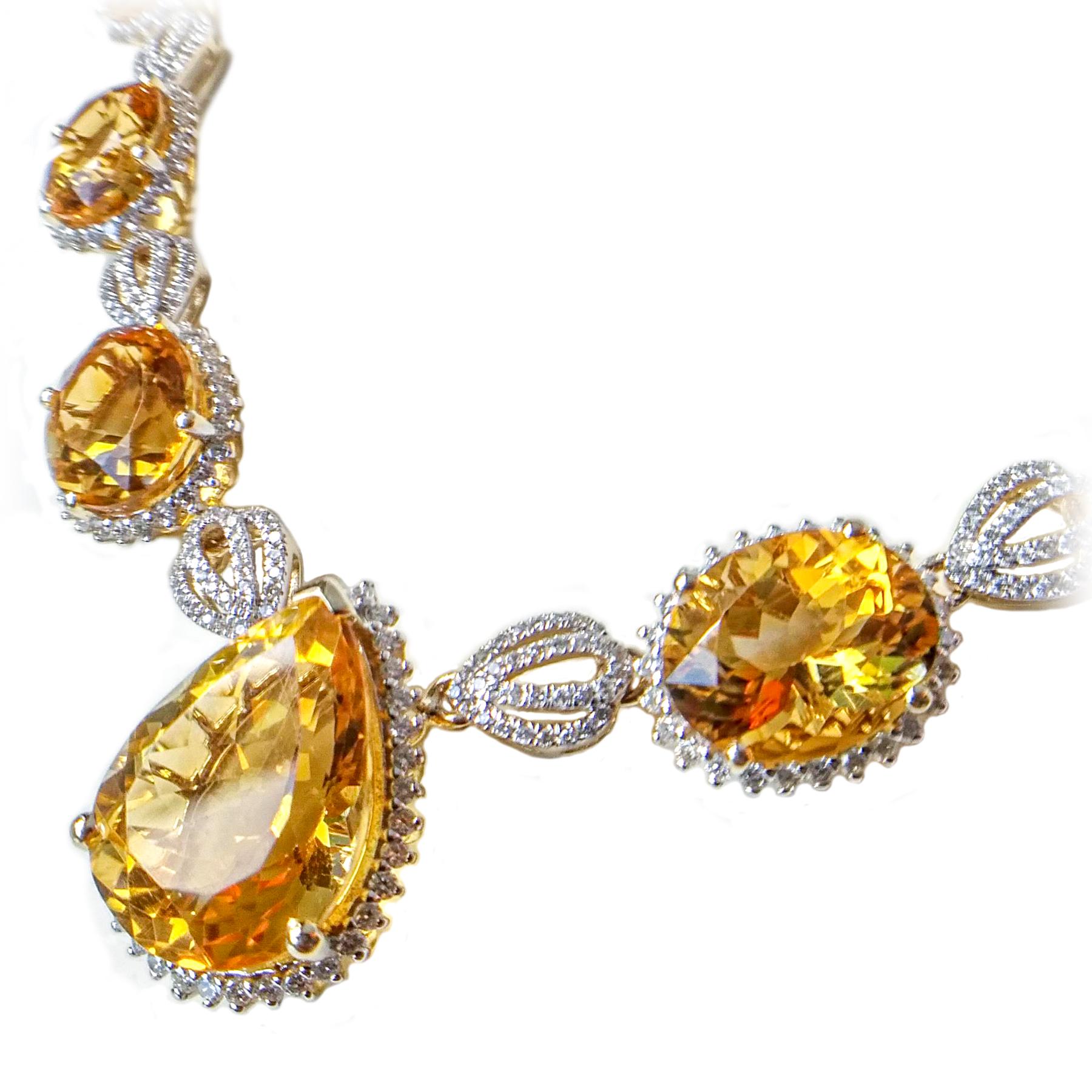 Striking citrine and diamond necklace earrings set. Handcrafted lively golden honey yellow, high luster, eleven matched, oval and pear shape 34.68 carats citrines encased in basket mounting, surrounded in round brilliant cut diamonds. Contemporary