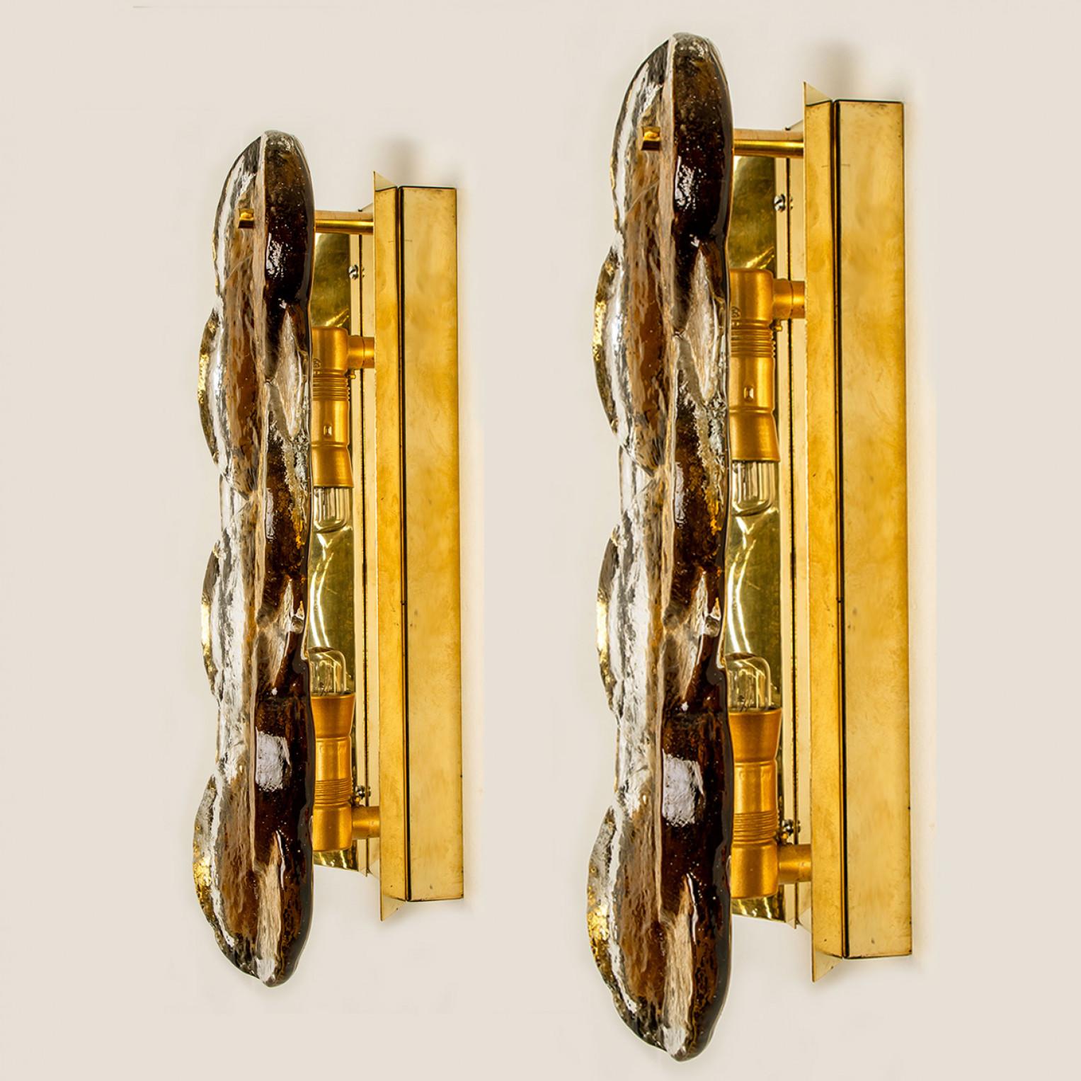 Kalmar swirl sconces wall lights with smoked citrus shaped glass, designed and manufactured in Austria, Europe by J.T. Kalmar/Kalmar Lighting in around 1969. Beautiful, thick textured glass is complimented by brass and metal hardware. Simple and
