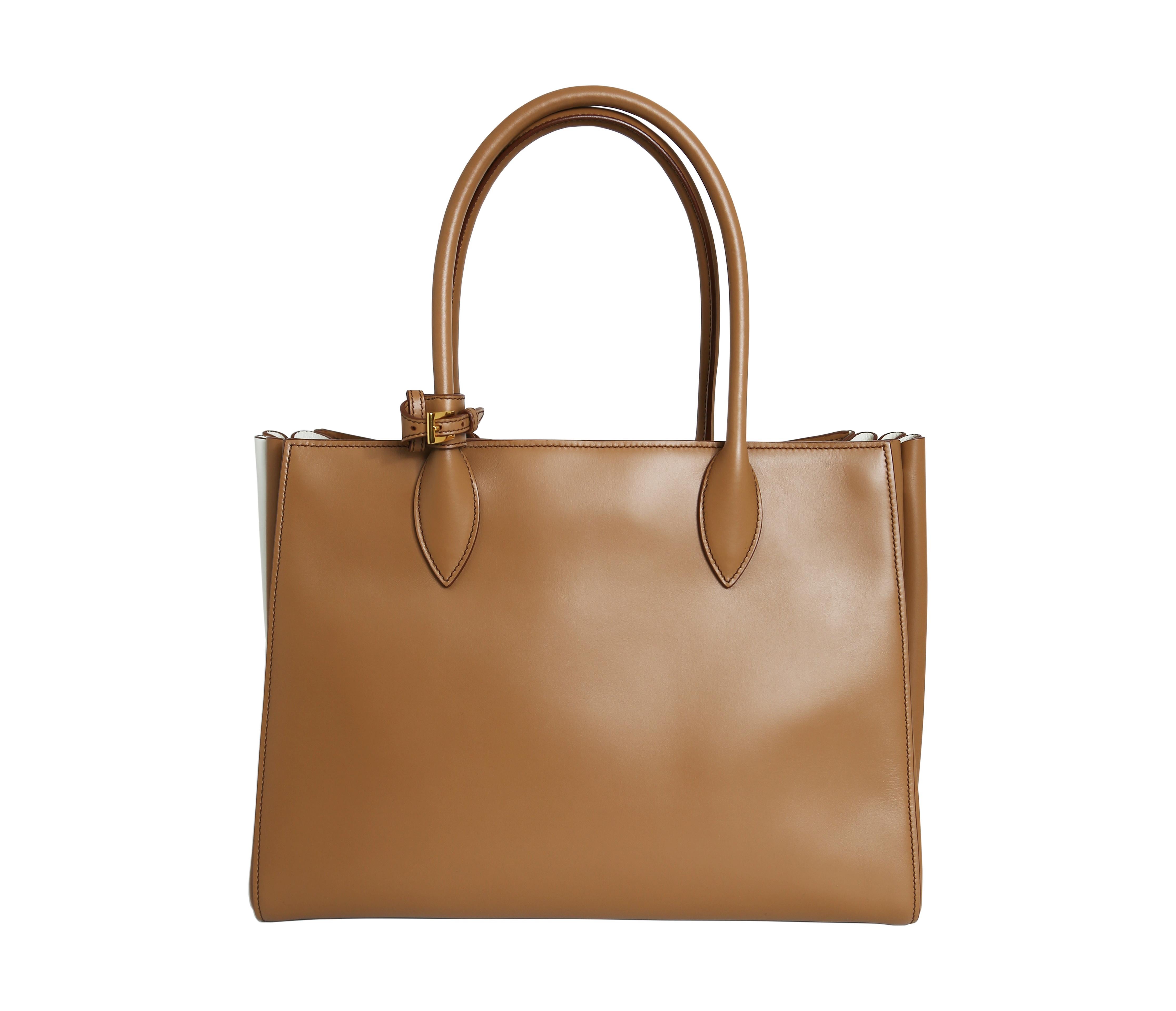 This Prada City Calf tote bag is expertly crafted from smooth calfskin leather in a warm caramel colour with talc accents. Versatile and chic, it comes with a long strap for easy wear and is brand new.

100% Calf Leather
Detachable strap
Spacious