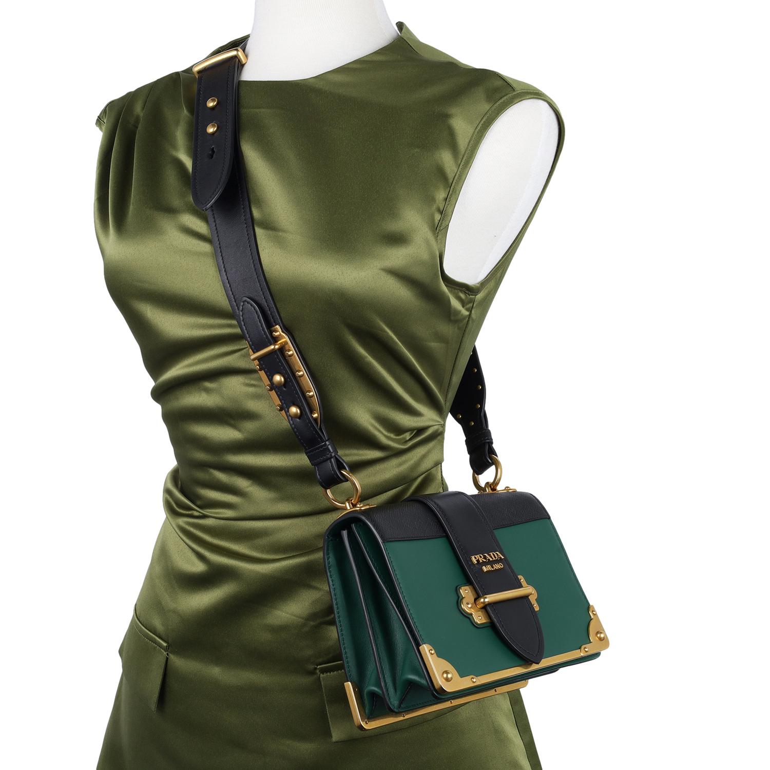 Authentic Prada City Calf Saffiano Cahier Bag in Biliardo Green and Black. This beautiful Prada bag is one the newest styles from Prada and is inspired by vintage trunks. The crossbody bag features calfskin leather in green and black, there is 