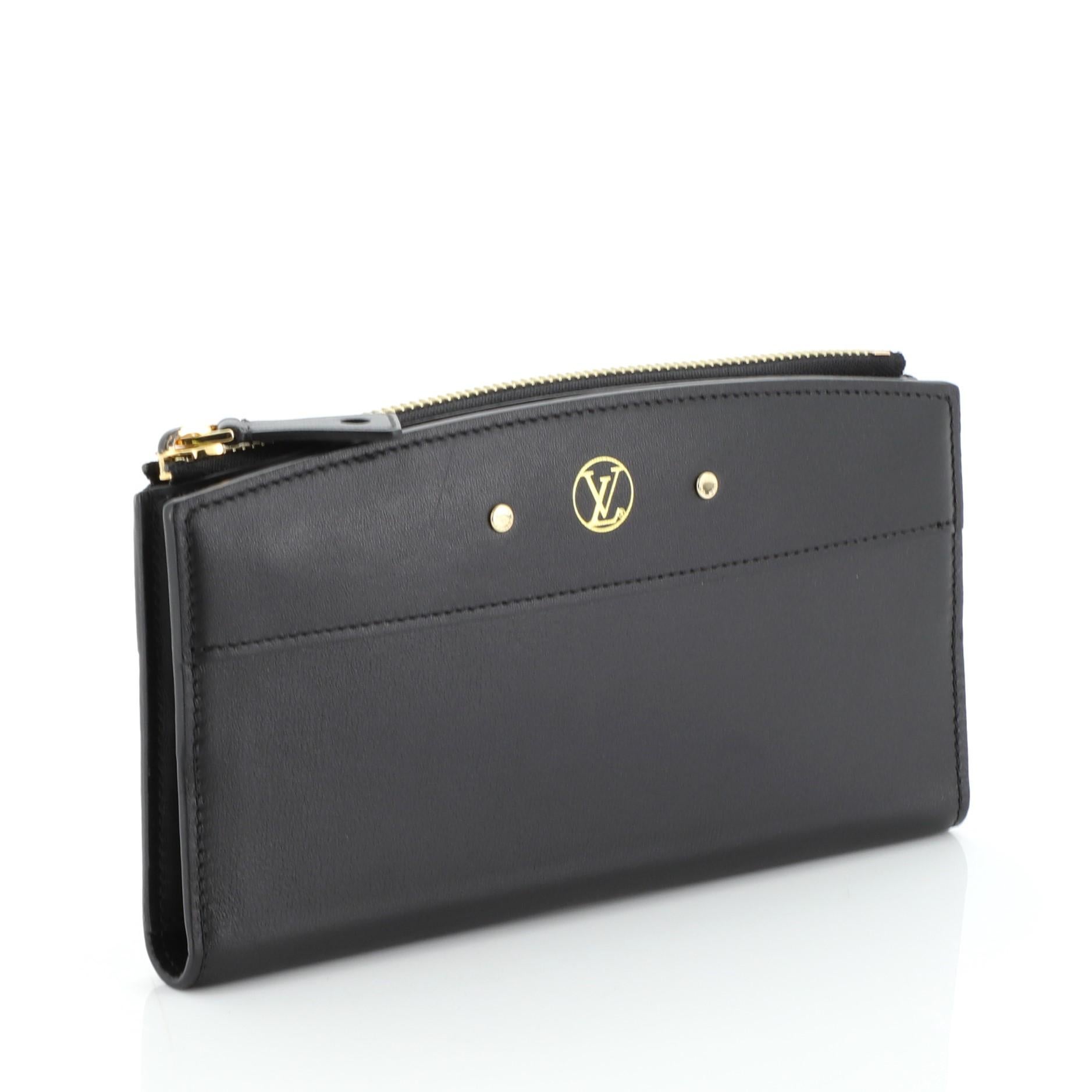 This Louis Vuitton City Steamer Wallet Leather, crafted from black leather, features signature LV logo and gold tone hardware. Its zip closure opens to a black leather interior. Authenticity code reads: MI1146. 

Estimated Retail Price: