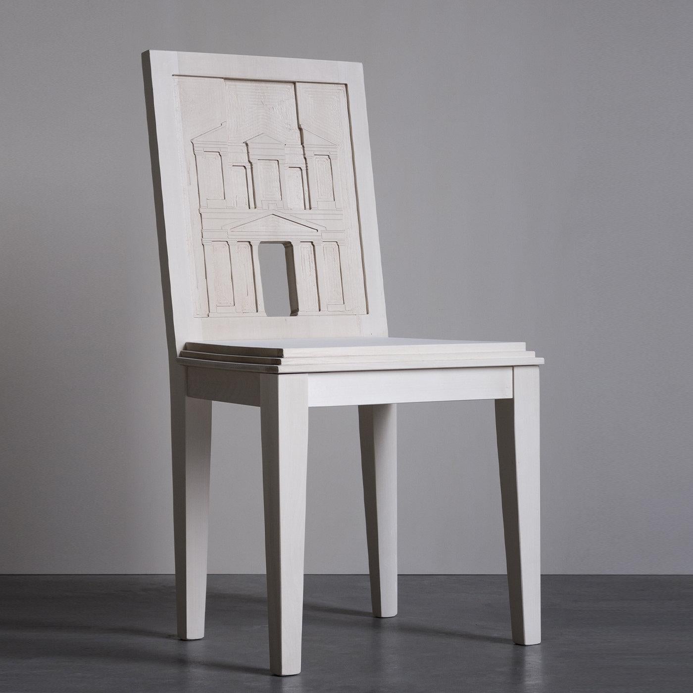 Inspired by the historical and archaeological city of southern Jordan Petra, this chair is distinguished by a magnificent hand-carved backrest that reproduces one of the city's sepulchers, originally carved in stone. Masterfully crafted of solid