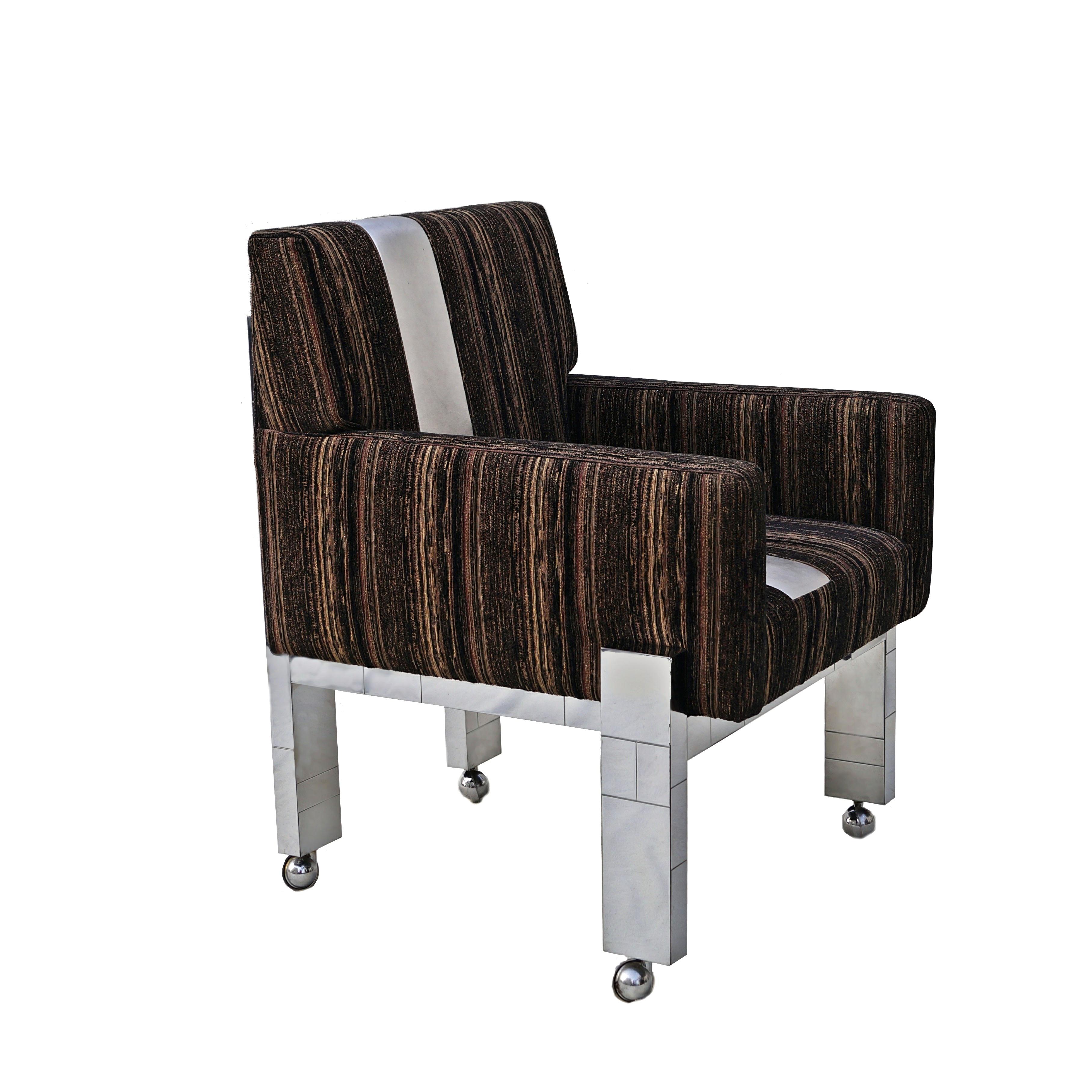 Chrome cityscape fabric desk arm side chair with castors by Paul Evans Inc. Has a metallic stripe on fabric. May work well as a vanity chair also, but check arm height, compared to your vanity or desk, if you want it to go fully under it. Arm height