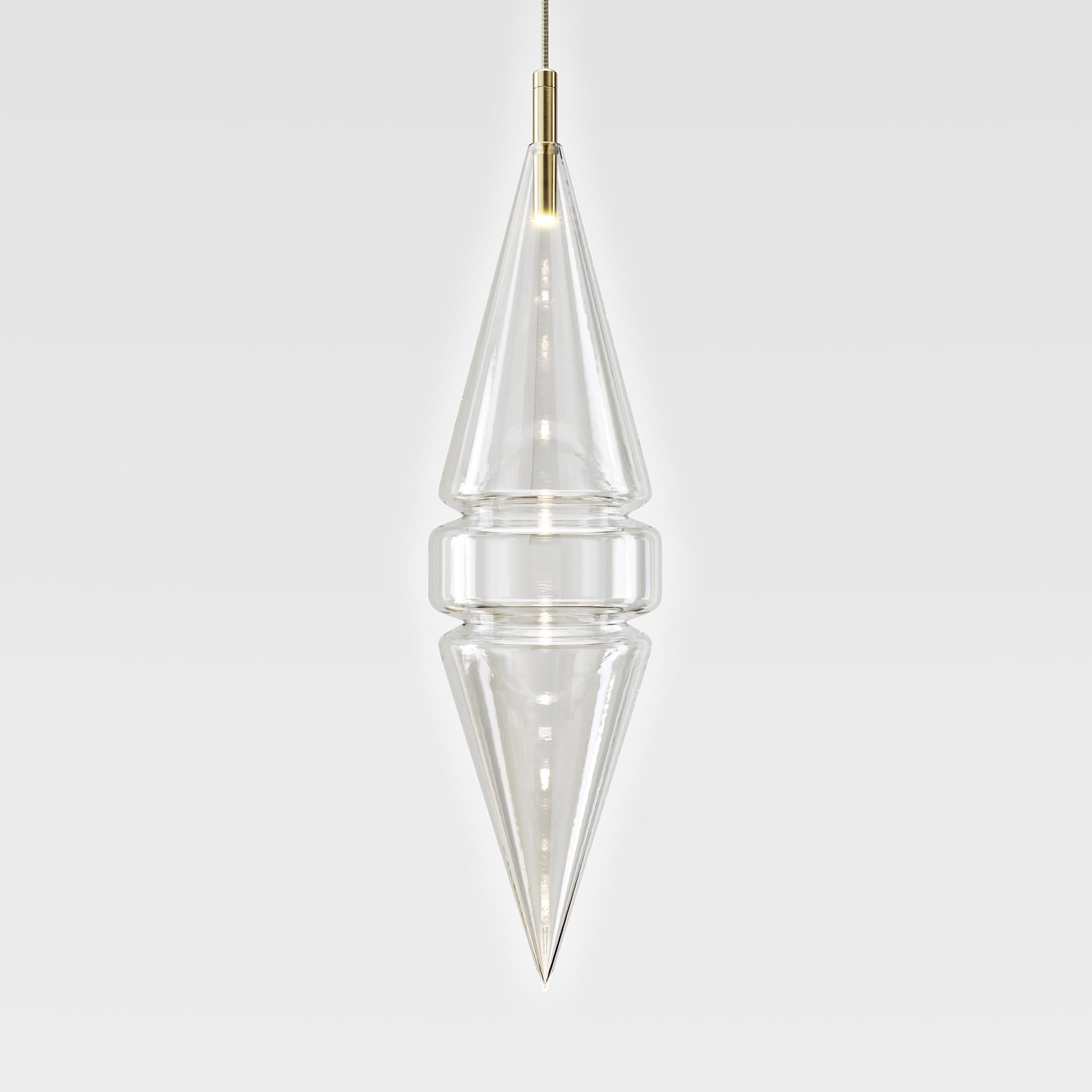 These mesmerising clear glass pendant lights are inspired by the scape of an imaginary city. Shapes and silhouettes, peaks and towers of a futuristic dreamscape. The precision of uniquely skilled medical glass manufacturers made this possible,