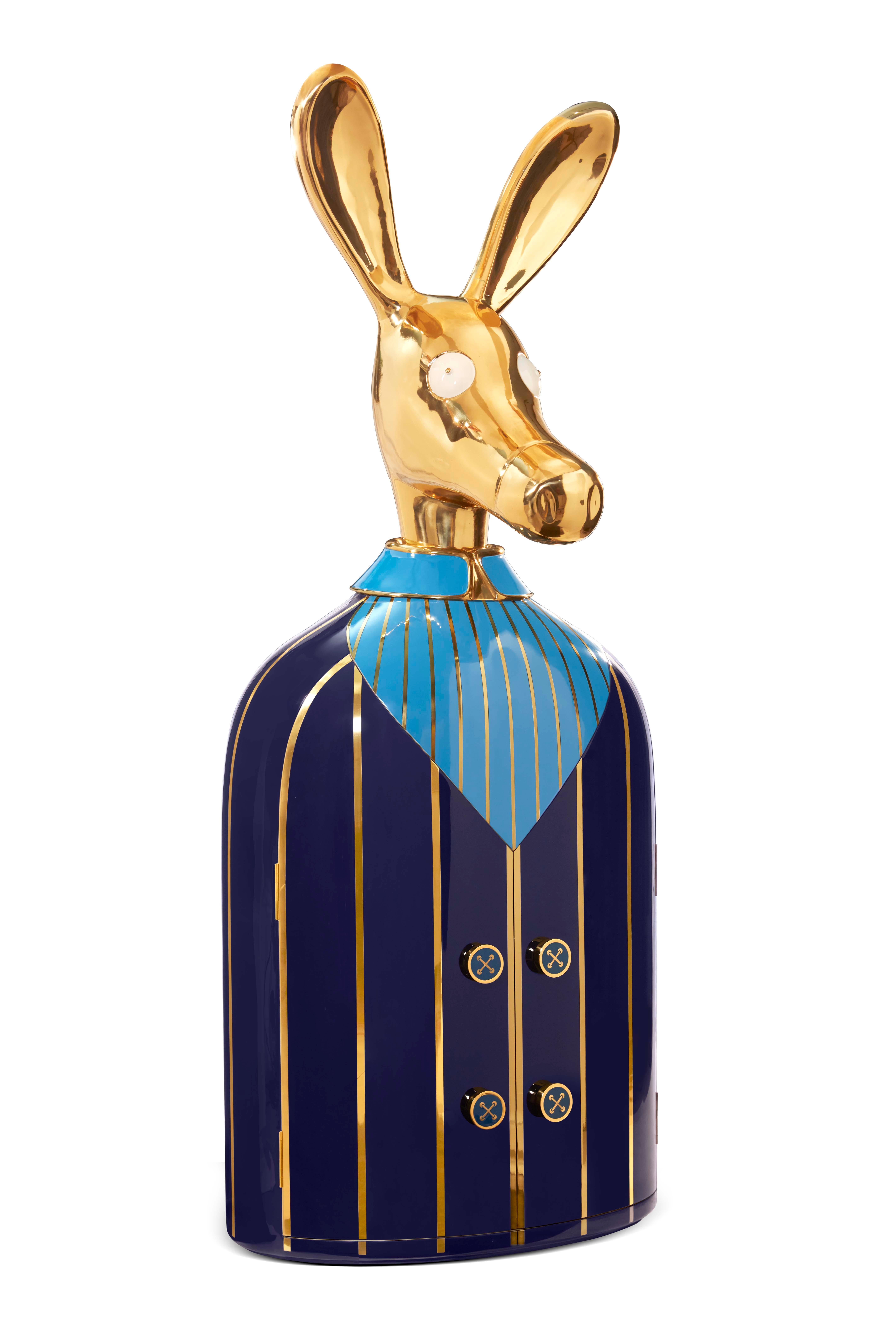 The Ciuco donkey blue bar storage cabinet with brass inlay by Matteo Cibic has a large brass donkey head that sits atop a brass and resin lined blue shirt. The buttons are knobs to open the tuxedo revealing a spacious cabinet within. A sculptural,