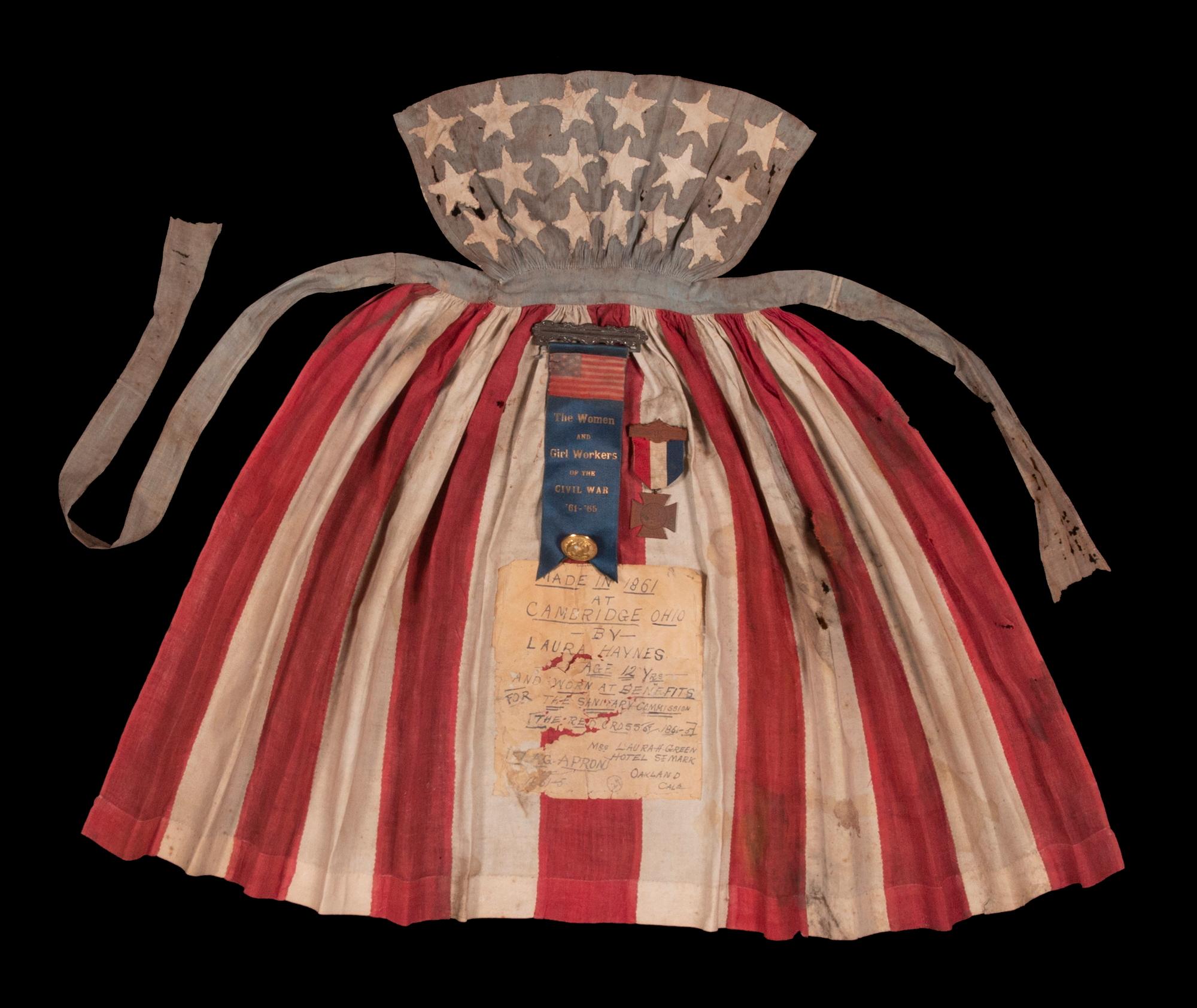 CIVIL WAR PERIOD APRON, MADE IN CAMBRIDGE, OHIO IN 1861 BY 12-YEAR-OLD LAURA HAYNES, WORN BY HER AT BENEFITS FOR THE U.S. SANITARY COMMISSION, PREDECESSOR OF THE RED CROSS, THAT STAFFED, FUNDED, AND MODERNIZED CIVIL WAR HOSPITALS

Laura Haynes was
