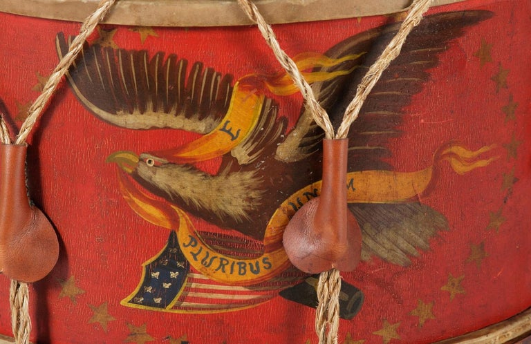 PAINT-DECORATED CIVIL WAR DRUM, MADE BY THE JOHN C. HAYNES COMPANY OF BOSTON, MASSACHUSETTS, 1861-63 

This beautiful Civil War drum has a vivid, scarlet red shell, on which an American eagle is painted with fine detail. The bird is perched in an