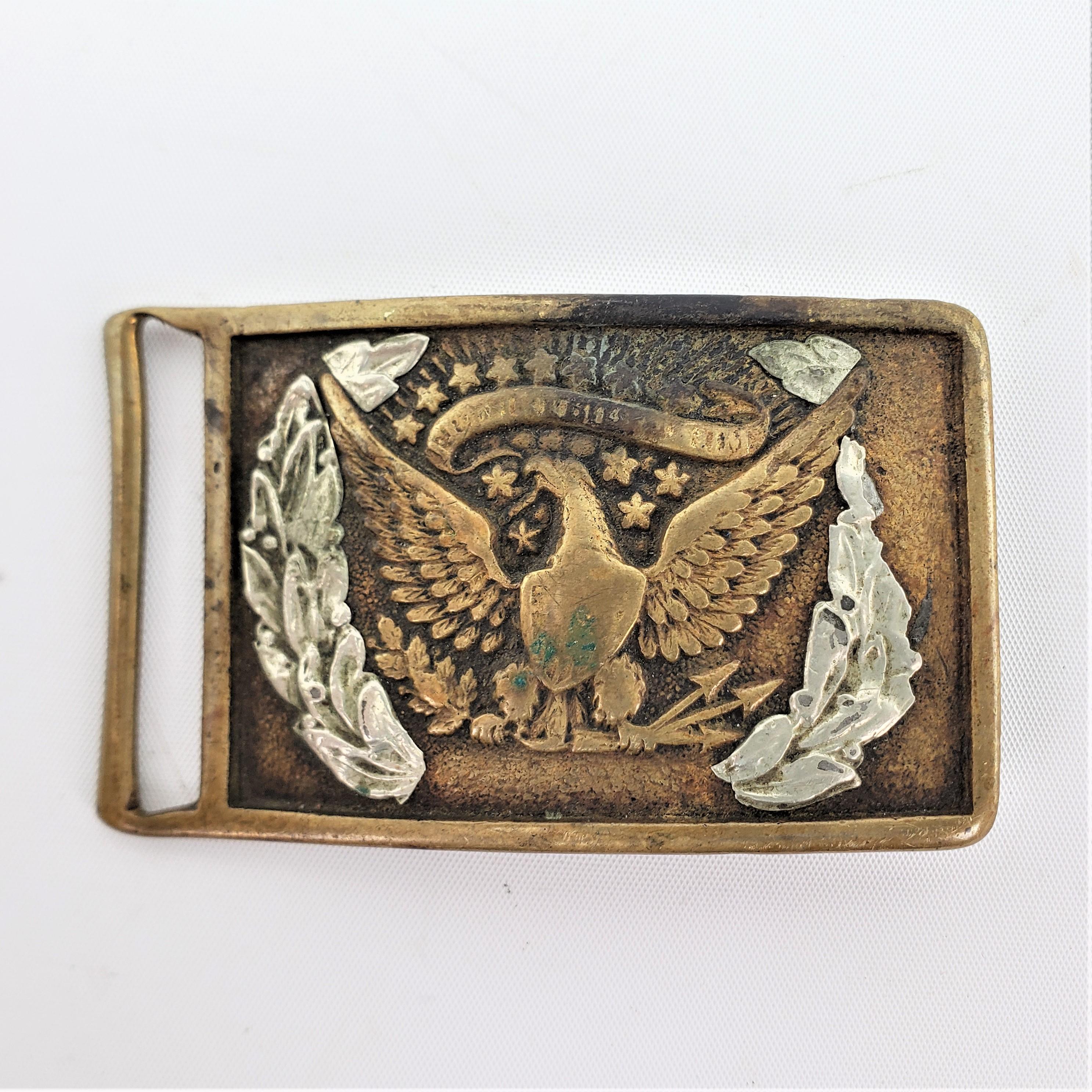 This brass Civil War era styled belt buckle is unsigned by the maker, but presumed to have been made in the United States in approximately 1851 in the period style. The buckle depicts an American eagle prominently in the center, with silvered