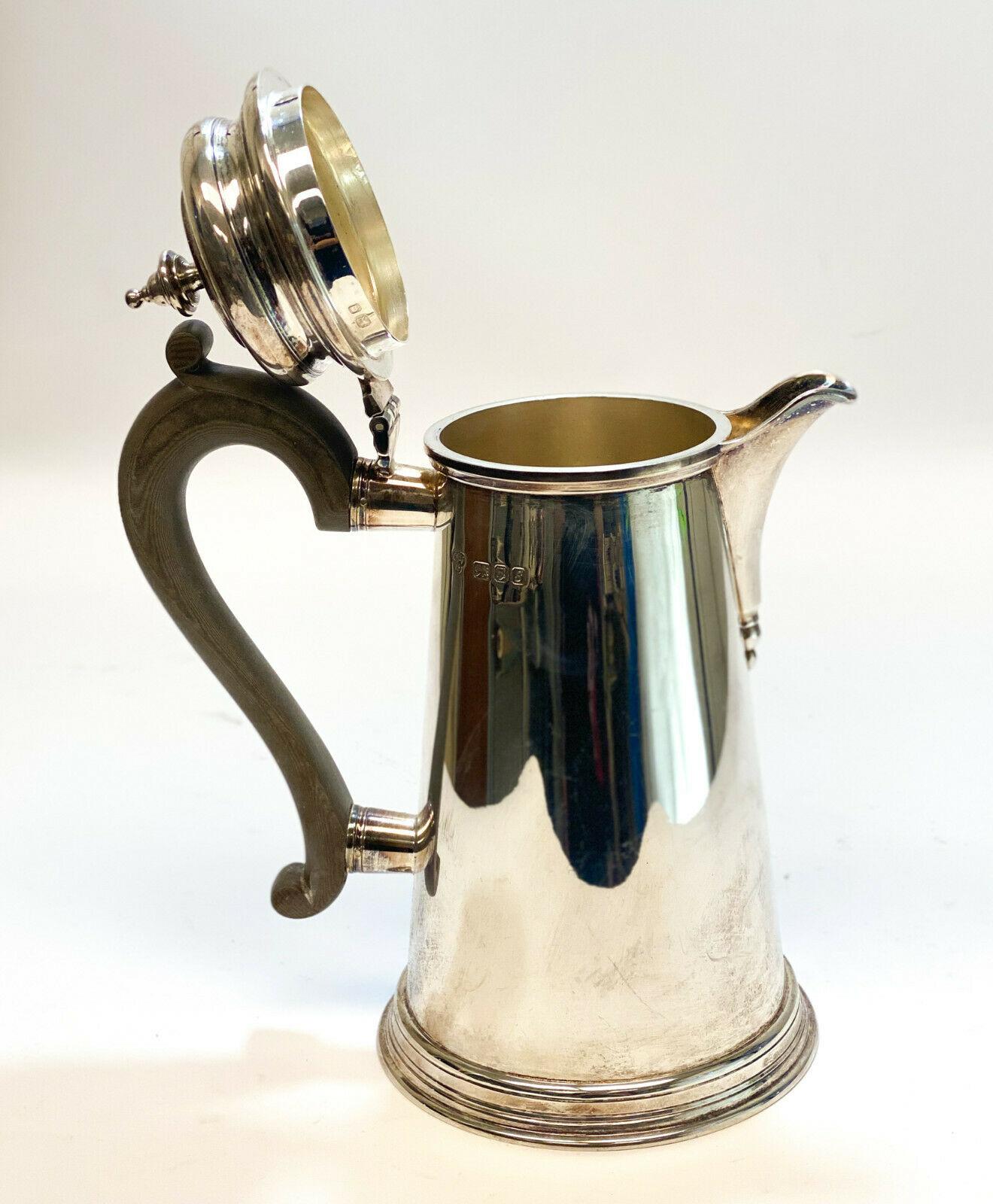 CJ Vander Ltd London Sterling Silver Georgian Style Tea Coffee Pot, 1973

Wooden Handle. CJ Vander Sterling silver hallmarks to the side and interior of the rim.

Additional Information:
Composition: Sterling Silver	
Age: Post-1940
Weight: 21.93