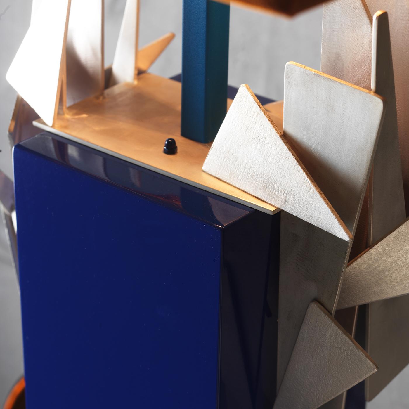If you are feeling inspired by the contemporary geometric trend, enhance your home decor with this striking wooden lamp. Its rectangular blue lacquered wood body is complemented by the orange velvet lampshade with golden interior. A decoration of