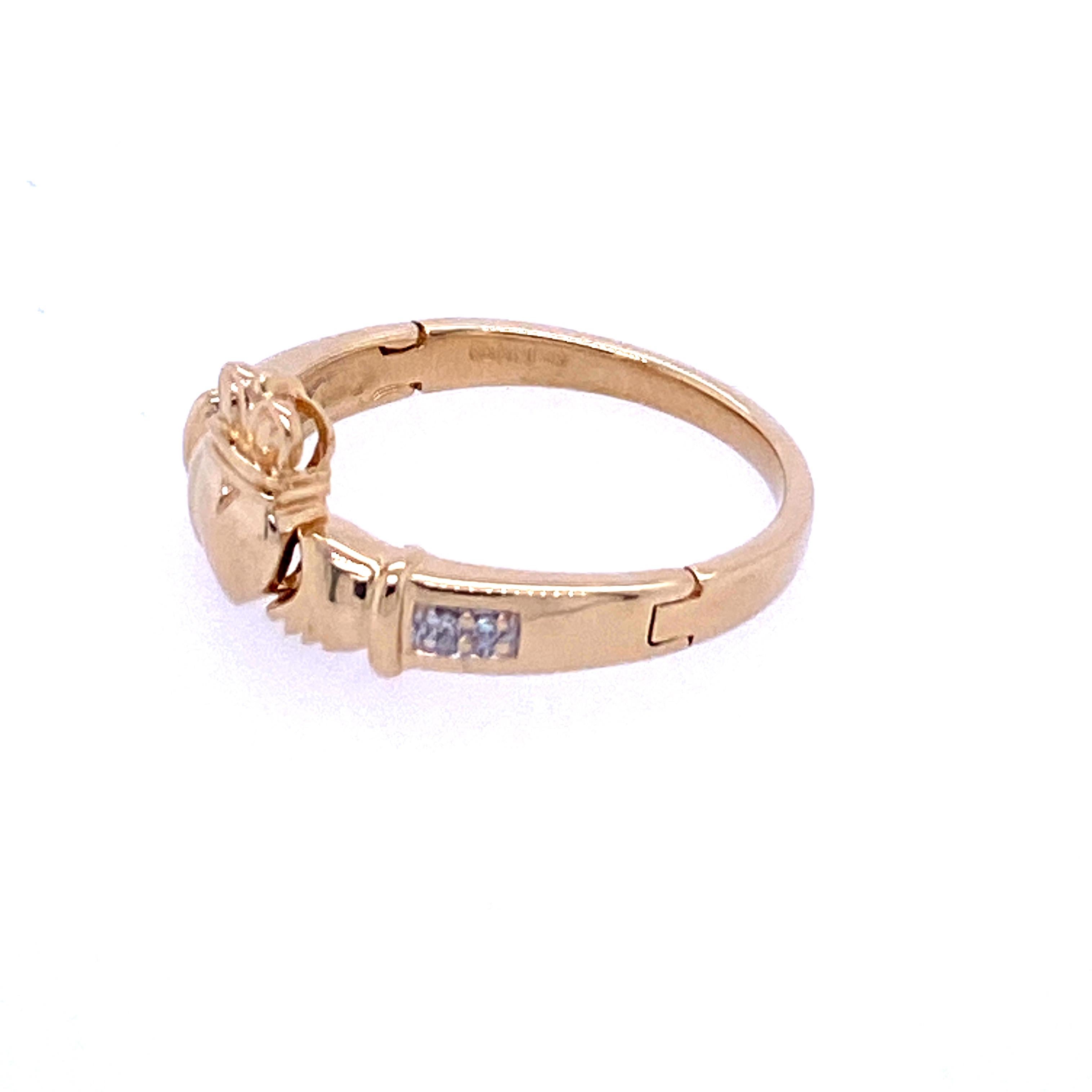 One 14 karat yellow gold (stamped SD 14 585 IRELAND)  Claddagh ring bead set with four single cut diamonds approximately 0.06 carat total weight with matching I/J color and S1/SI2 clarity. The ring features hinged shoulders which open to disclose a