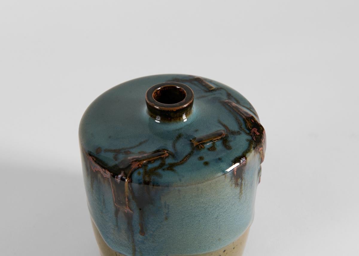 This unique vase by Swedish ceramist Claes Thell possesses the kind of rough beauty for which he is well-known the world-over among enthusiasts of Scandinavian ceramics. 

Thell developed an enthusiasm for the medium at a young age and gained a