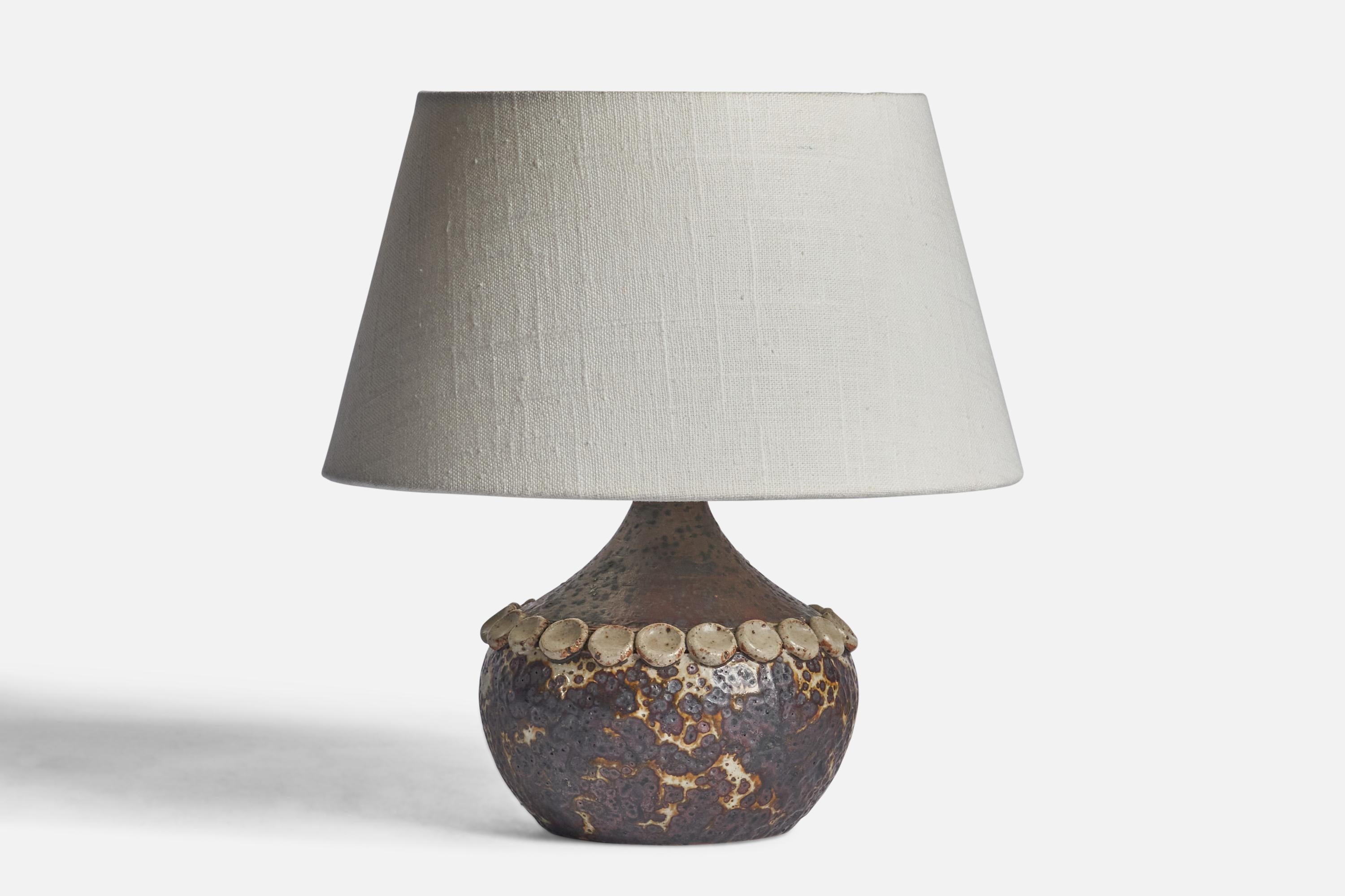 A grey and brown-glazed stoneware table lamp designed and produced by Claes Thell, Sweden, c. 1970s.

Dimensions of Lamp (inches): 7.25” H x 5.75” Diameter
Dimensions of Shade (inches): 7” Top Diameter x 10” Bottom Diameter x 5.5” H 
Dimensions of