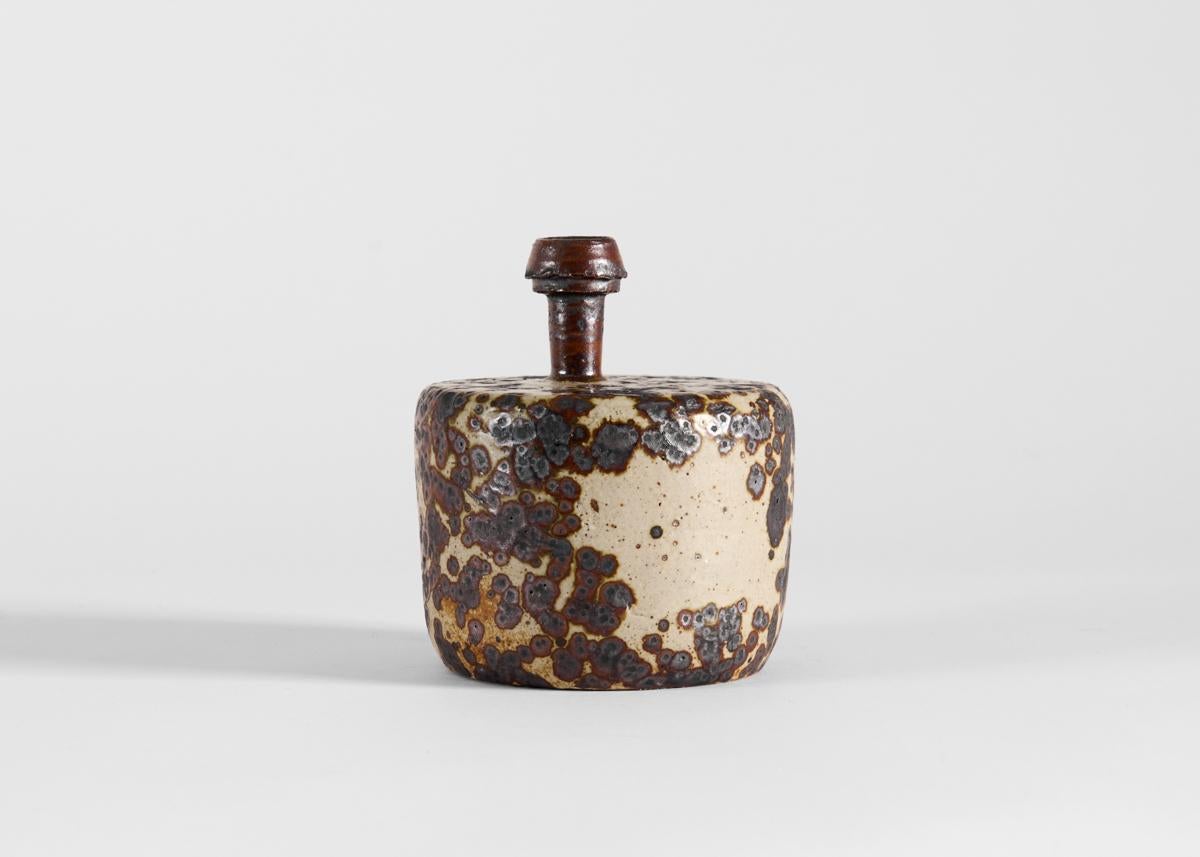 This unique vase by Swedish ceramist Claes Thell possesses the kind of rough beauty for which he is well-known the world-over among enthusiasts of Scandinavian ceramics. 

Thell developed an enthusiasm for the medium at a young age and gained a