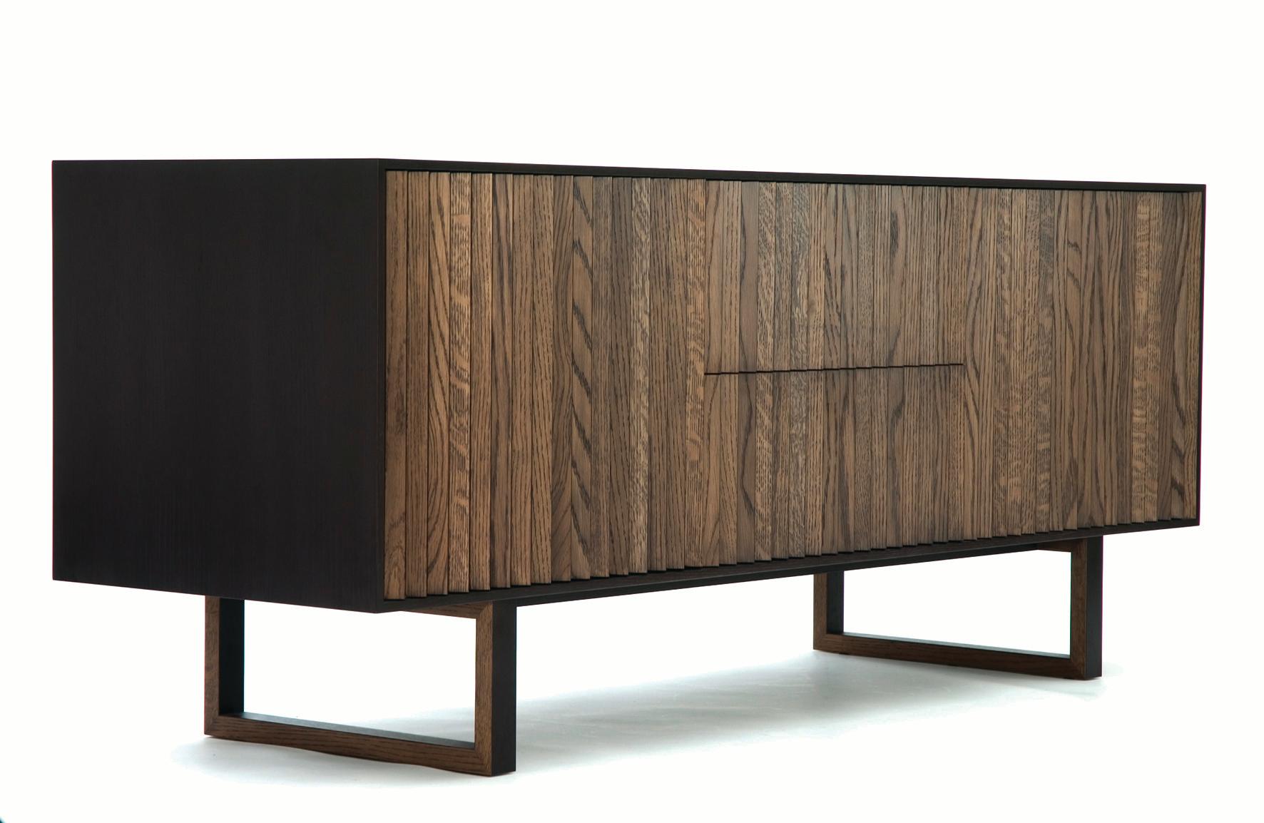 The clair sideboard features multifaceted front panels, stained in two tones creating an unusual effect, as the sideboard appears to change color on perspective. It is lovingly handmade to order by a single artisan with great attention to detail: