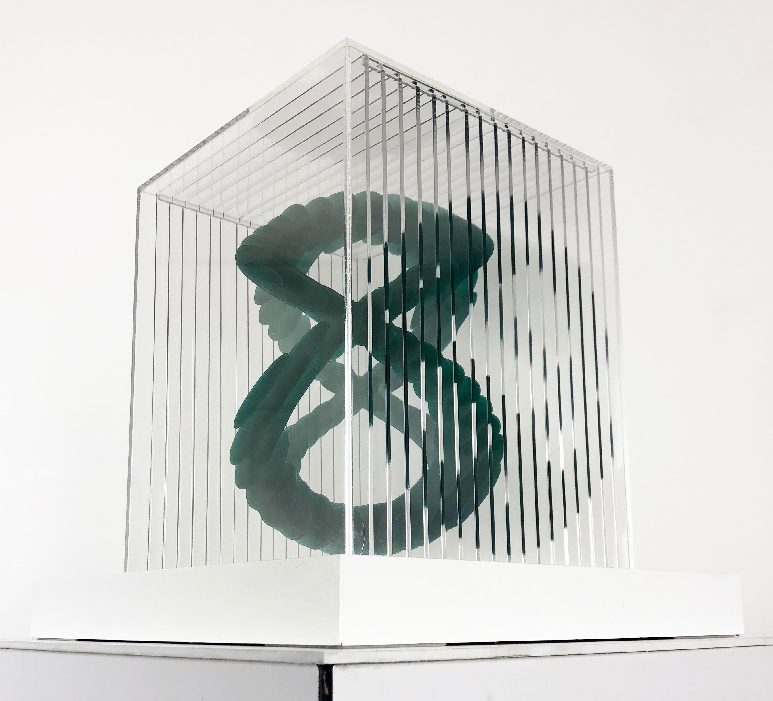 Two Cubed by Claire Cohen, 2018

Created using acrylic, plexiglass and wood. Artist signature on the base of the piece. Piece appears lighter in natural lighting conditions, changing to a darker teal when not directly lit. 

Claire Cohen is an