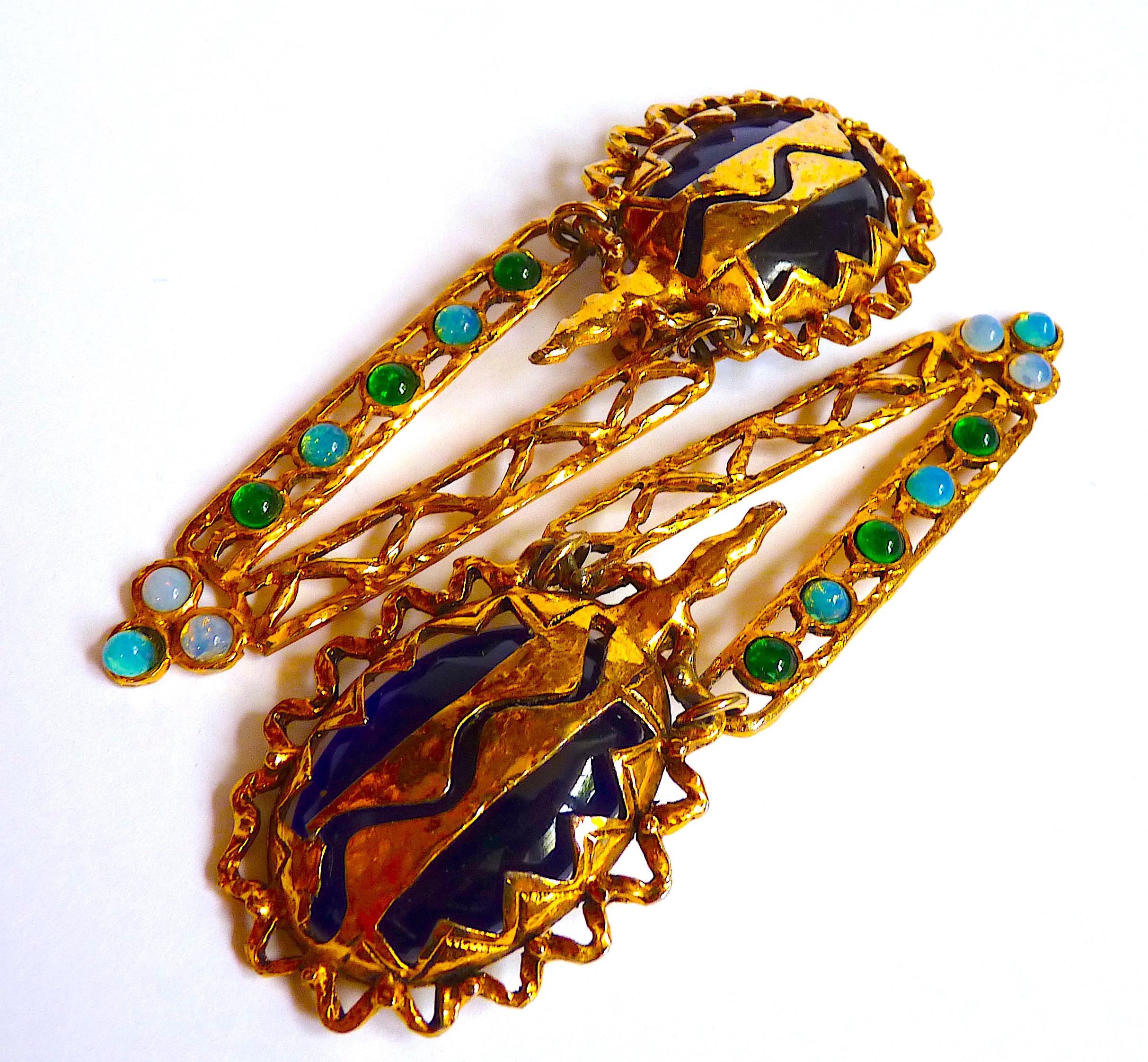 Very Long Claire Deve Pendants, Vintage from the 80's, with a large blue glass cabochon adorned with gilt metal, and a very long gilt metal pendant with small blue-green cabochons

Signed CLAIRE DEVE PARIS at back of 1 clip

CONDITION : Very nice