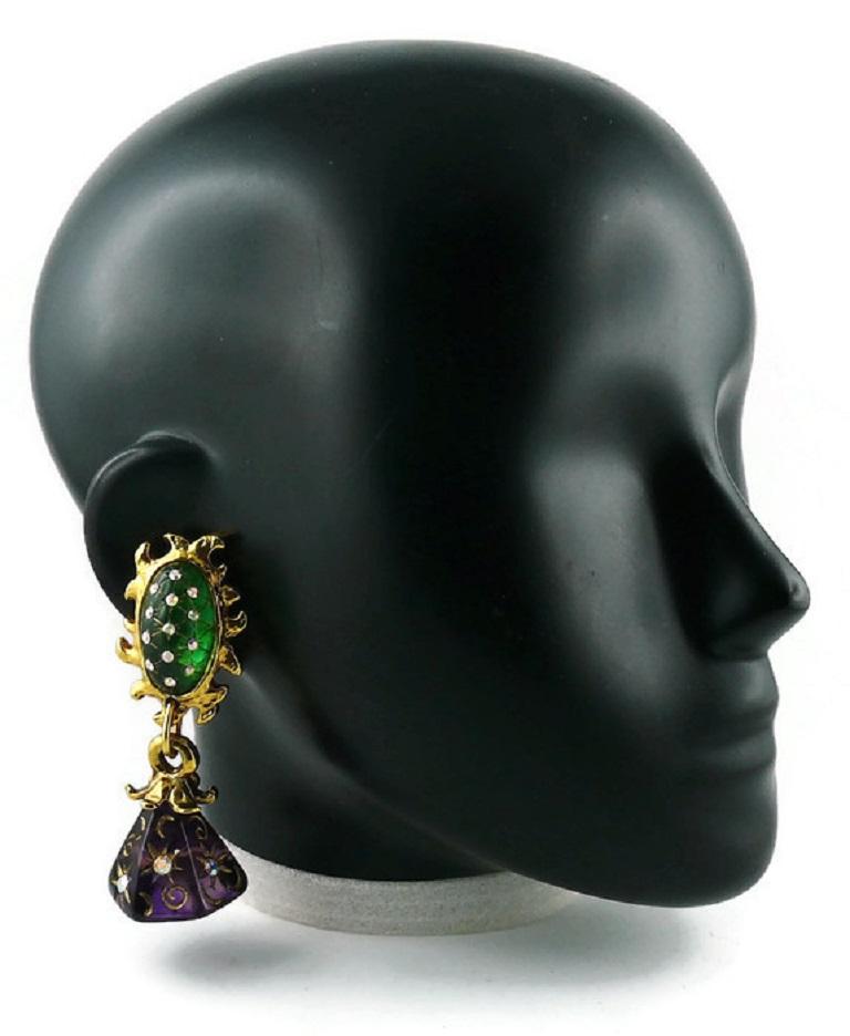 CLAIRE DEVE vintage celestial gold toned dangling earrings (clip-on) featuring abstract sun top, stars and moons embossed on green and purple resin cabochons, aurora borealis crystals embellishement.

Embossed CLAIRE DEVE Paris.

Indicative