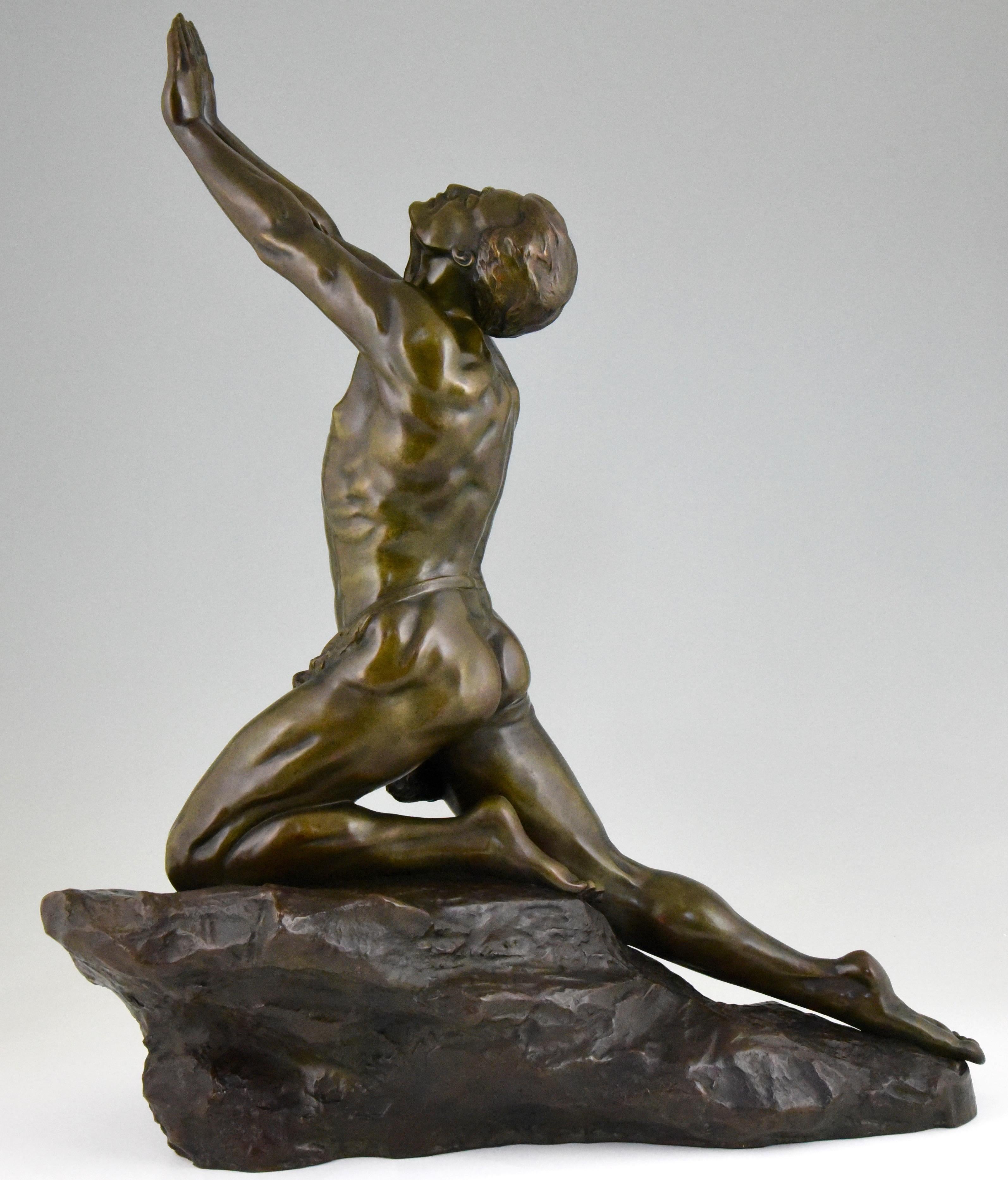 Beautiful quality large bronze sculpture of a kneeling male nude on a rock entiteld 